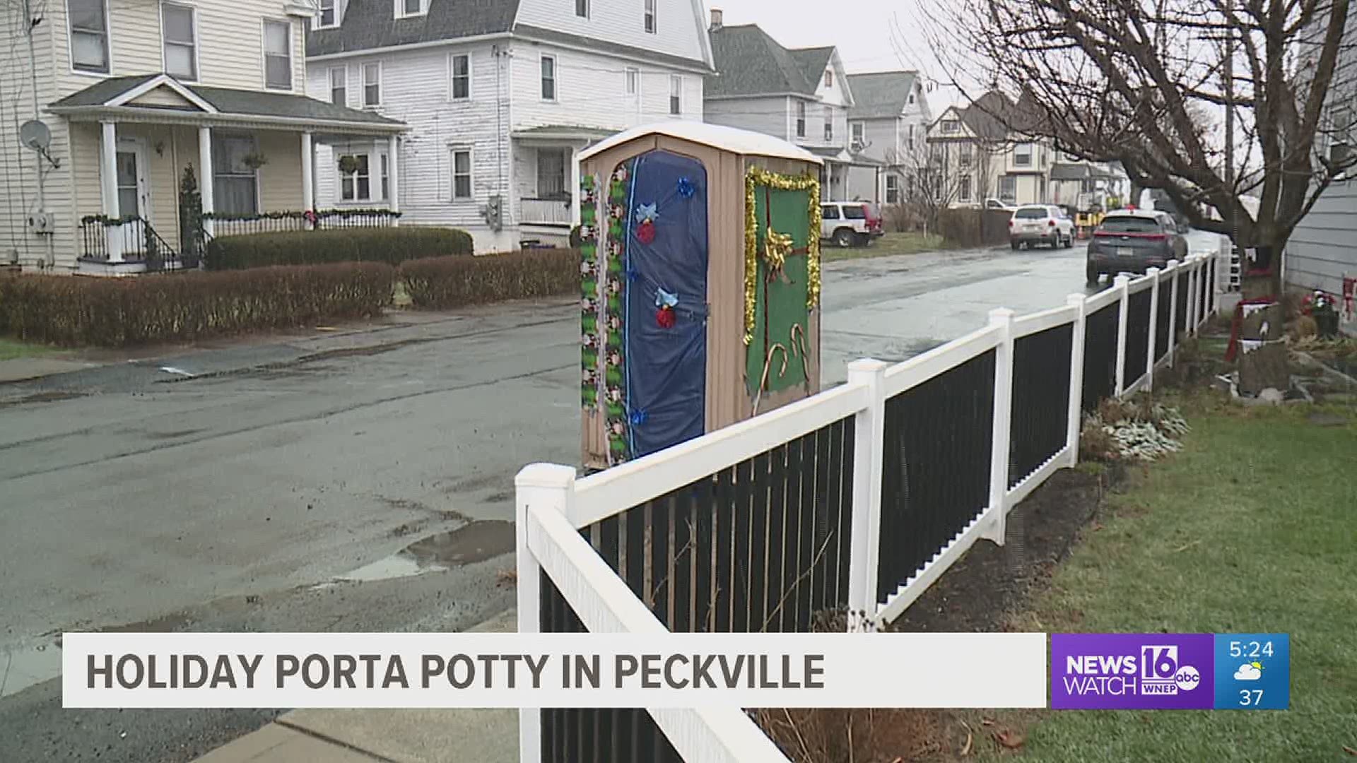A Porta-Potty in Peckville has been covered in wrapping paper, tinsel, and candy canes.