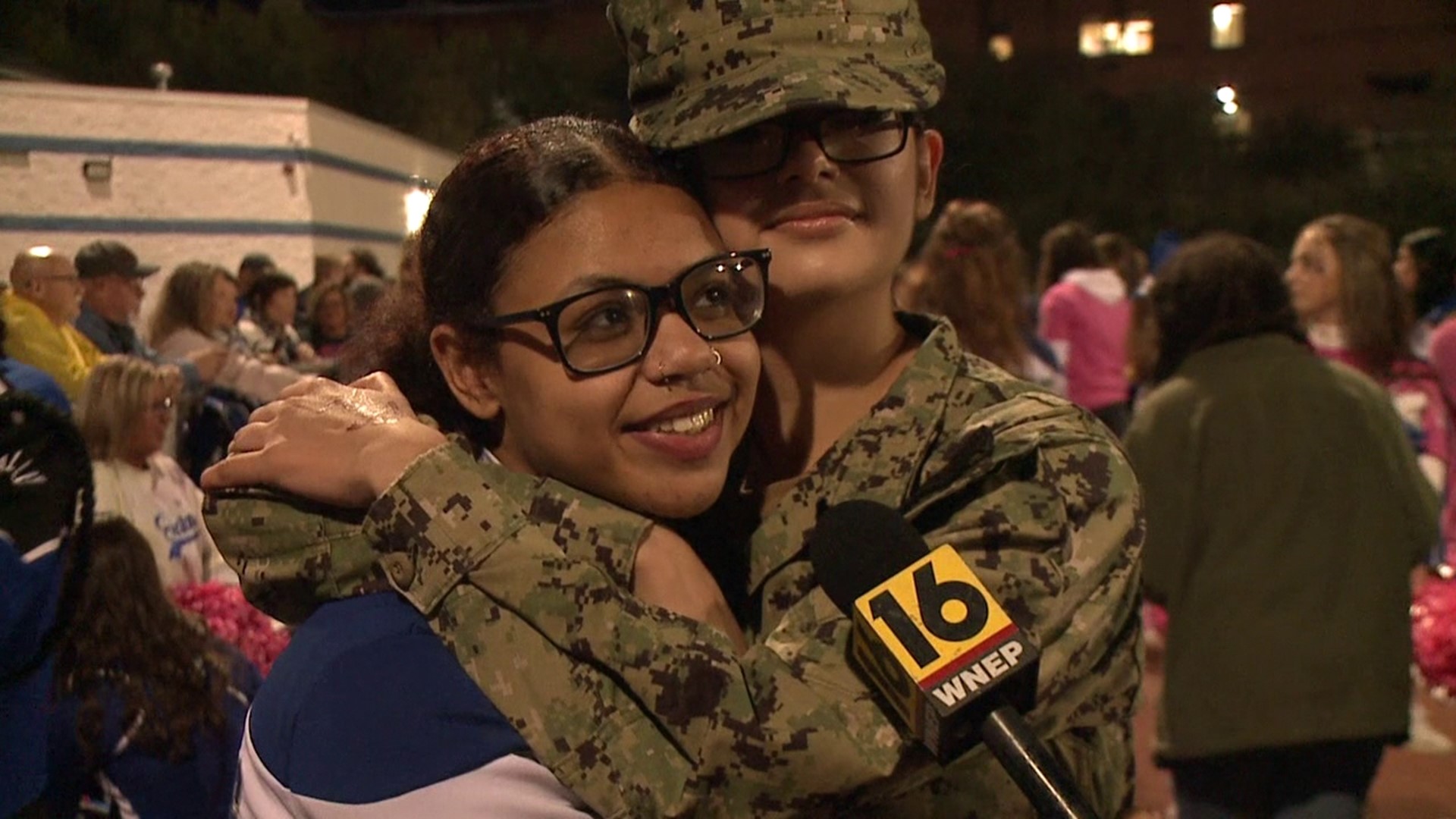 Two sisters, one a cheerleader and the other currently serving in the U.S. Navy, reunited with the help of faculty, family, and Friday night lights.