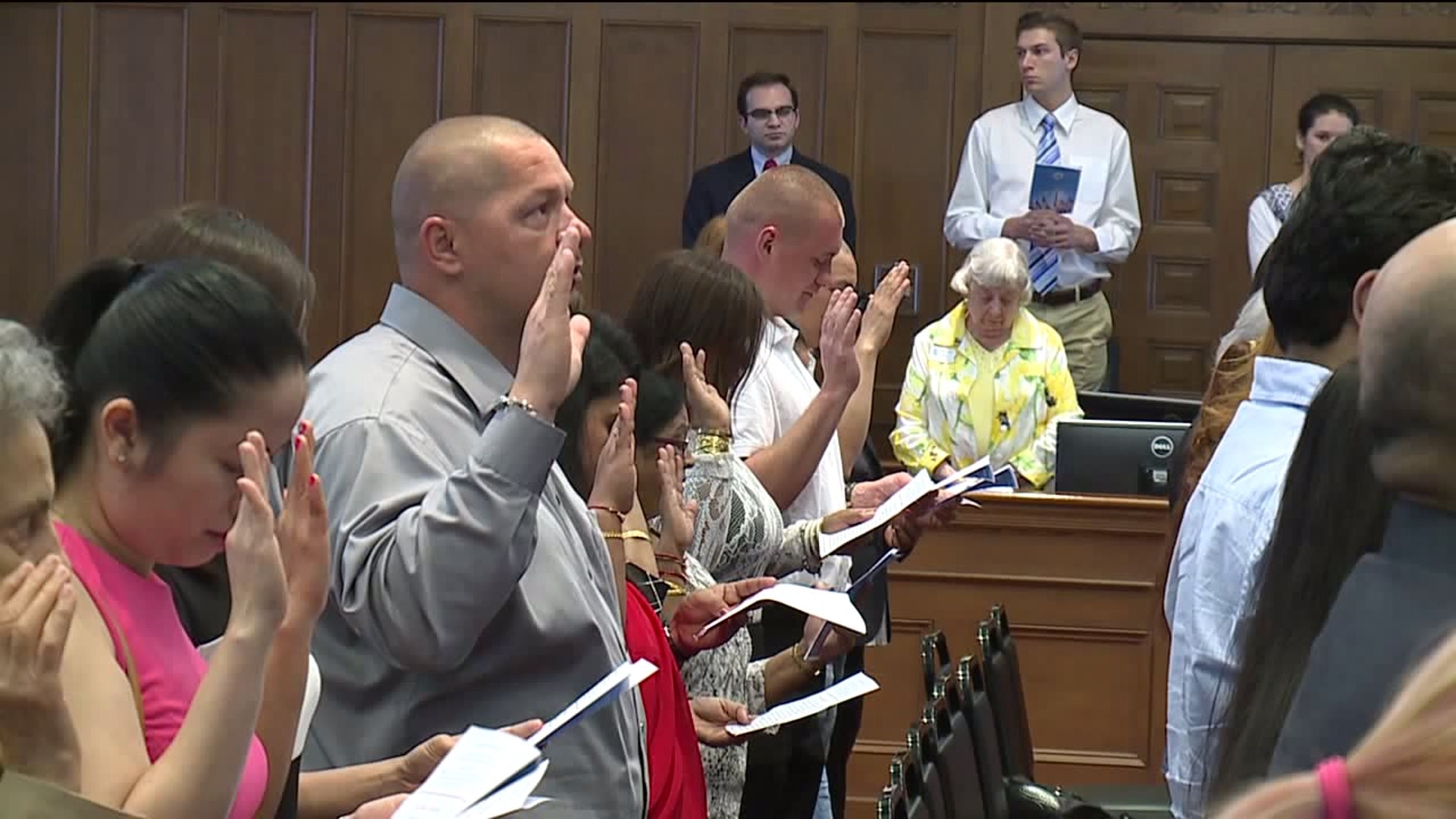 Newly-Minted Americans Take Oath of Citizenship