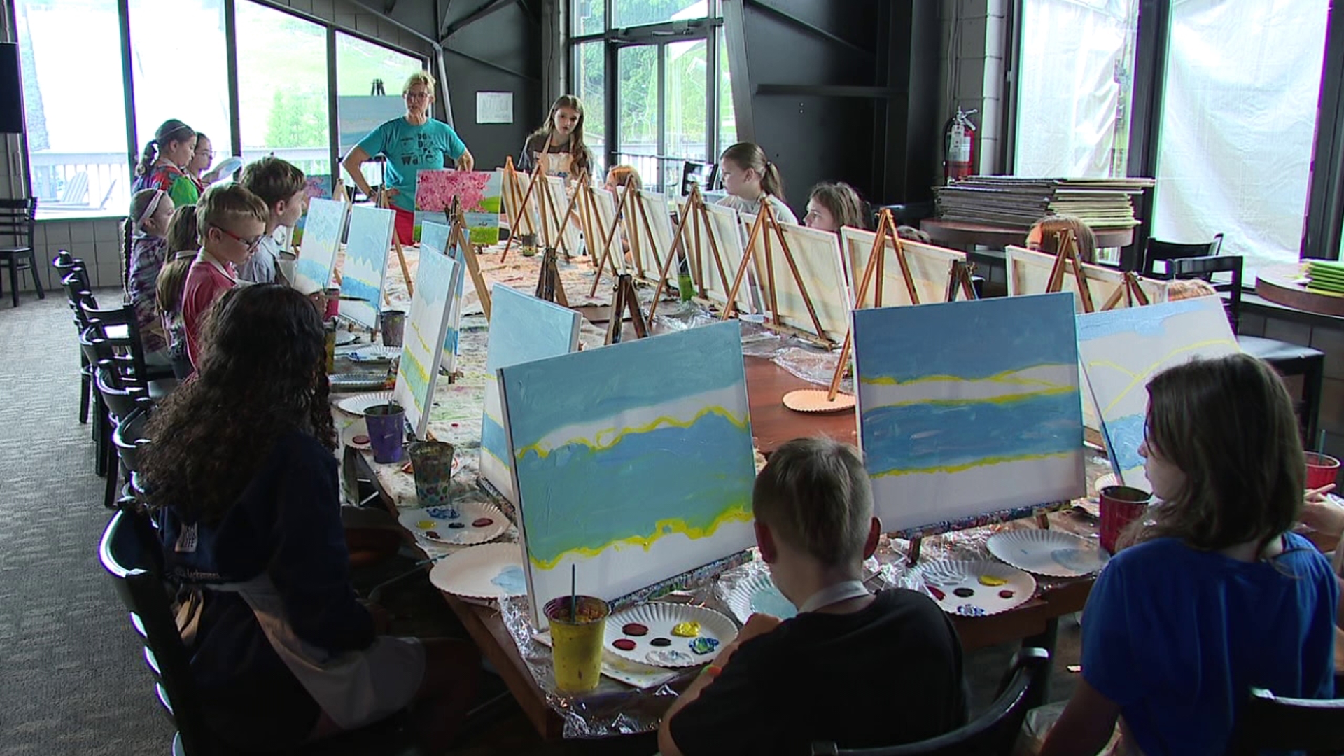 Some paint helps transform a blank canvas into a beautiful landscape of color. But each stroke of the brush is helping transform these campers, as well.