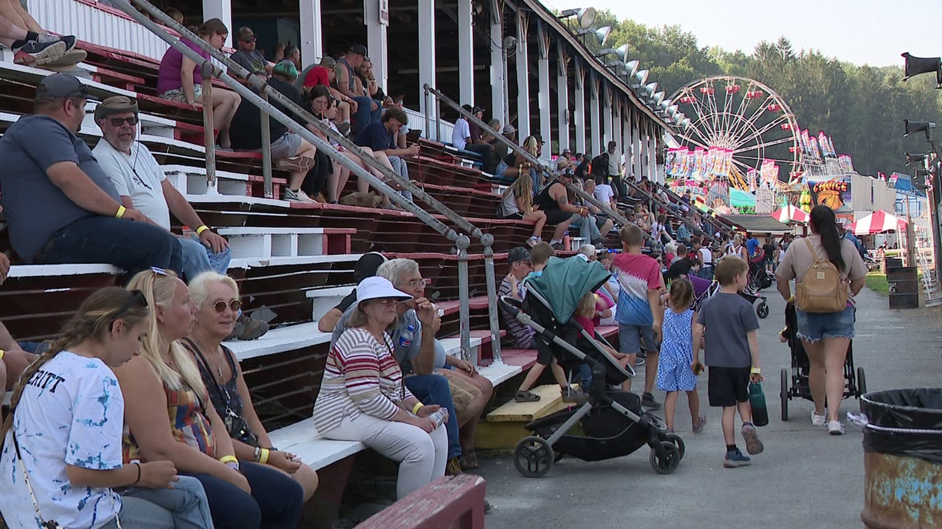 Fairgoers enjoy rides, games, and live entertainment at the Wayne County Fair on day three near Honesdale.