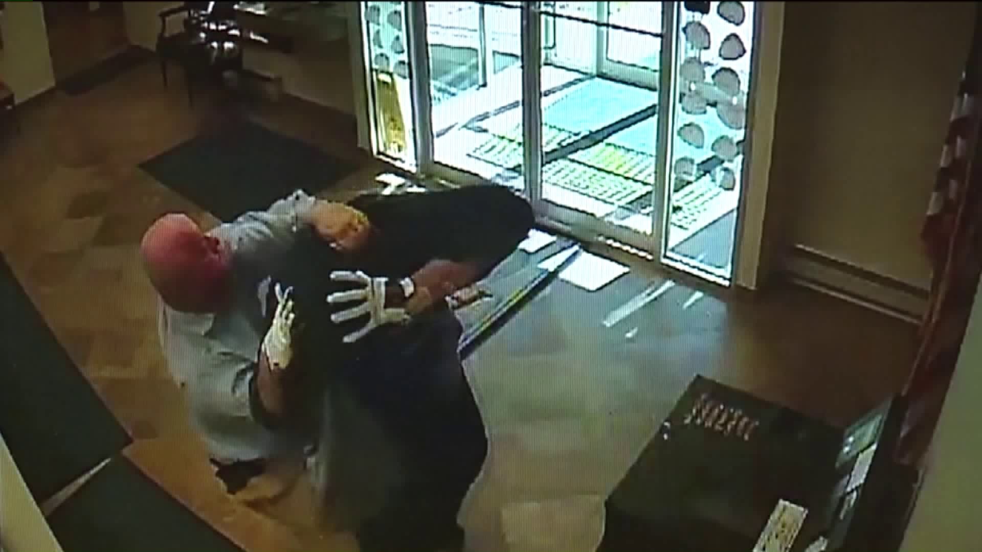 Surveillance Video Shows Customer Tackle Armed Bank Robber
