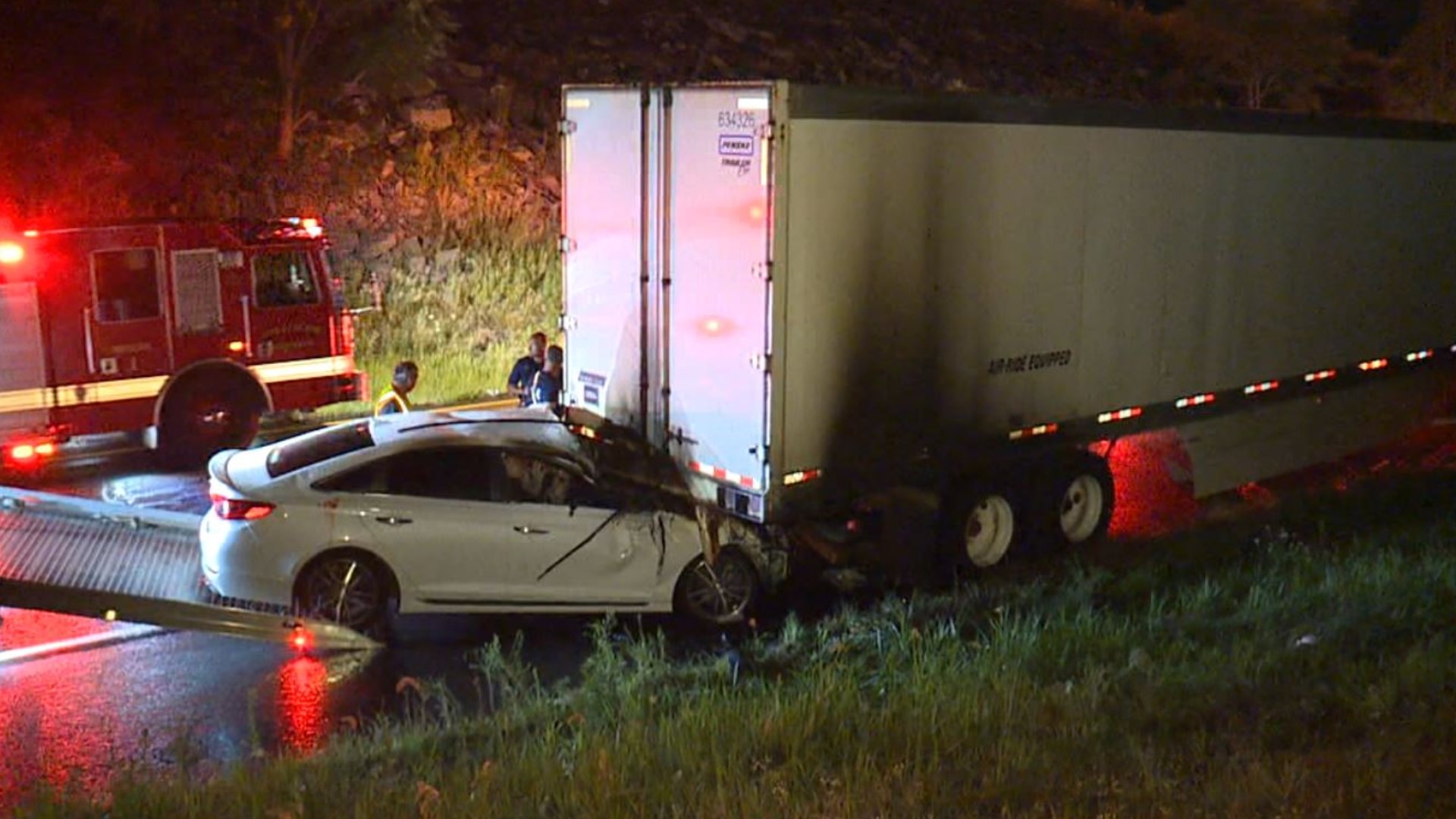 Officials say a car hit a truck parked on the side of the road. The car caught fire and spread to the big rig.