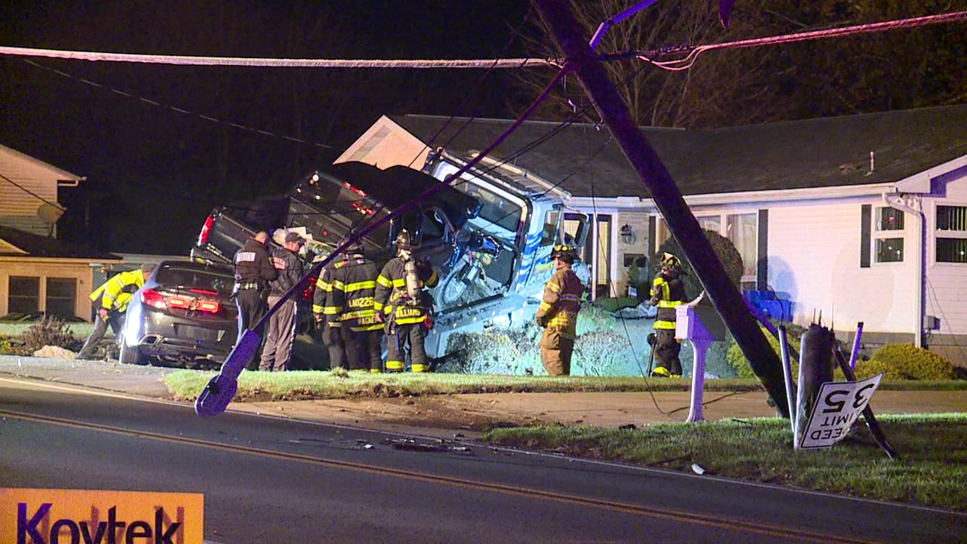 Truck Hauling Two Cars Crashes, Narrowly Missing Home