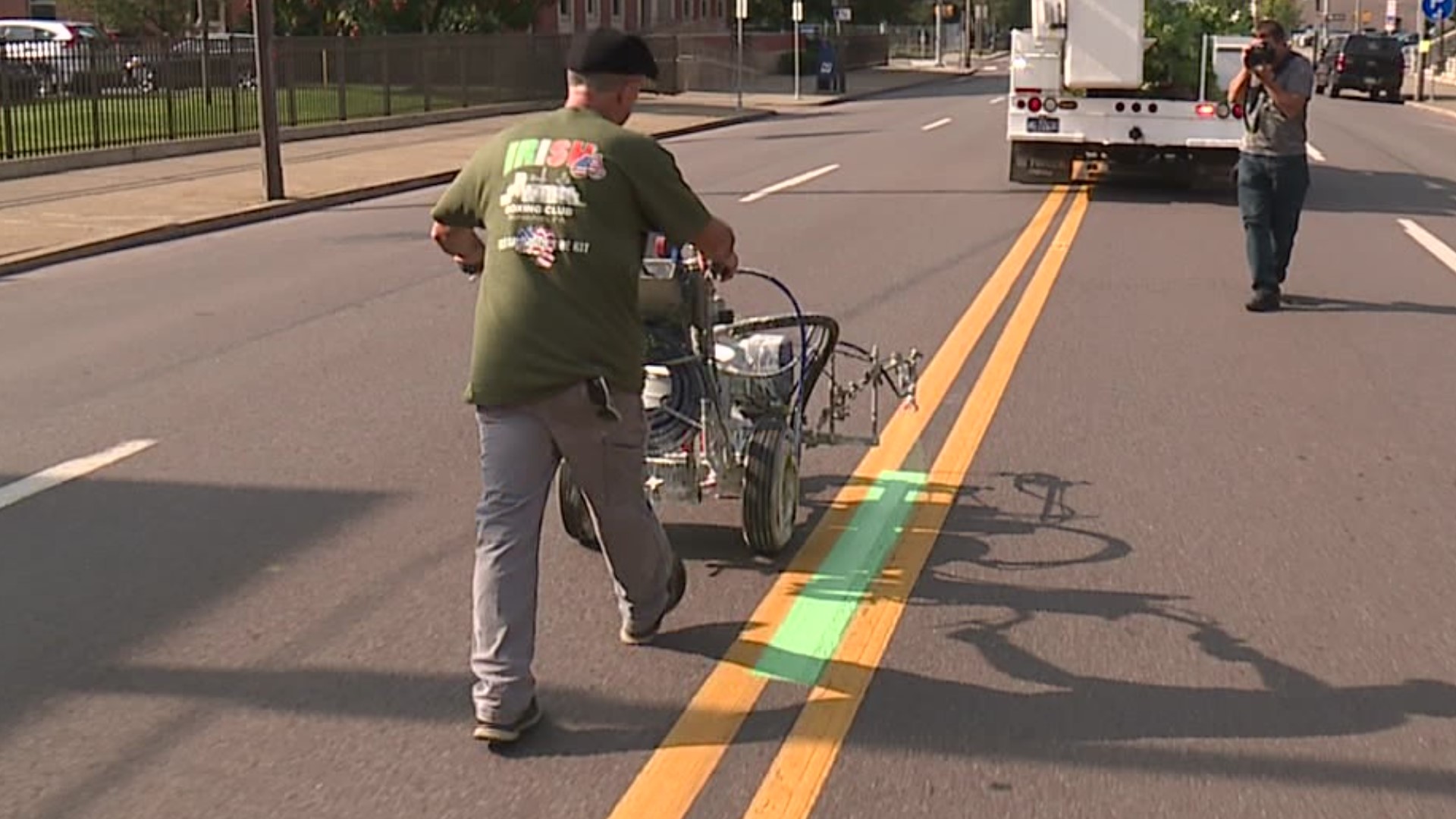 Crews were out Wednesday morning painting the green line for the parade route downtown.