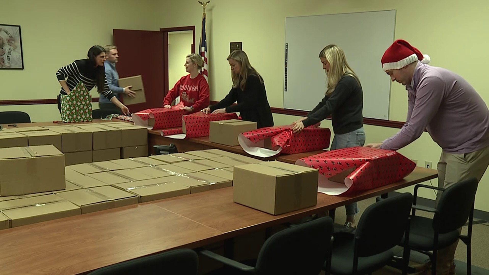 Volunteers pitch in to wrap gifts for the holidays