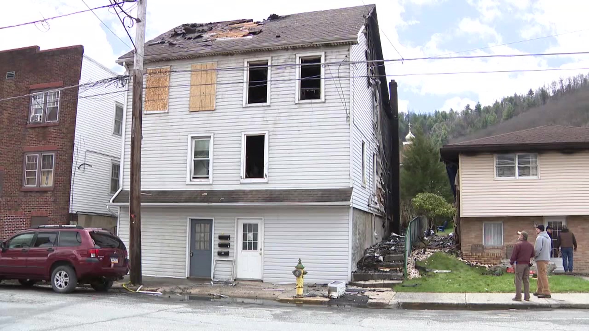 Flames forced a dozen people out of their homes, damaging an apartment building and two homes in Carbon County.