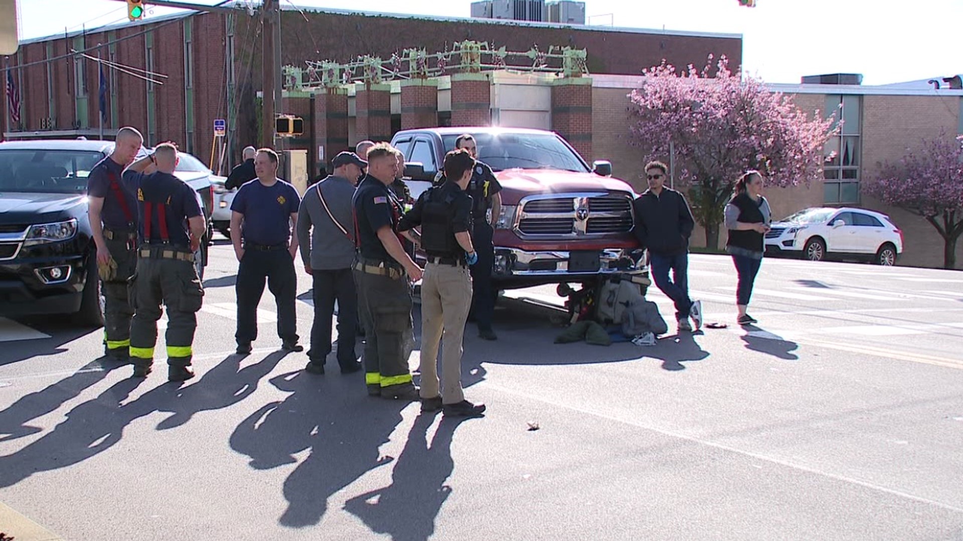 A pedestrian on a mobility device was hit by a pickup truck while crossing the street.