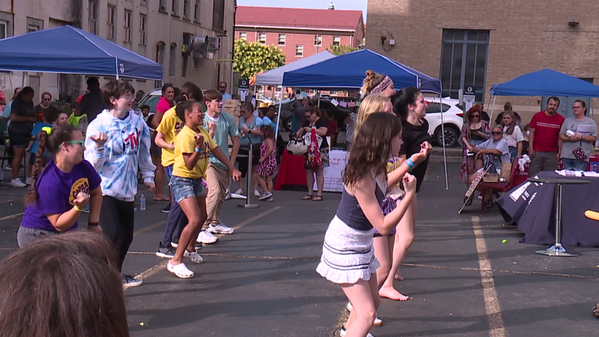 Organizers distributed 150 backpacks filled with pencils, notebooks, and other essentials to students.