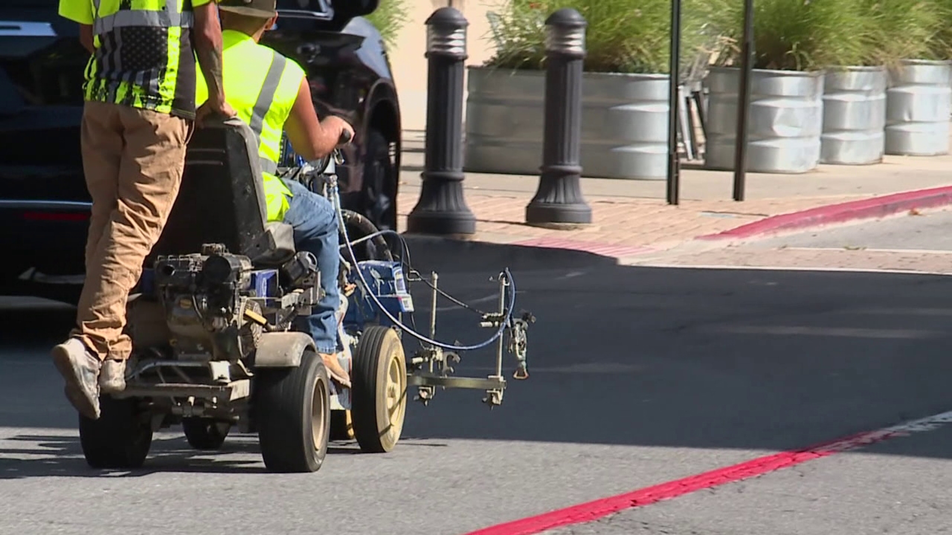 Crews were out painting Main Street red in preparation for the Tomato Festival this weekend.