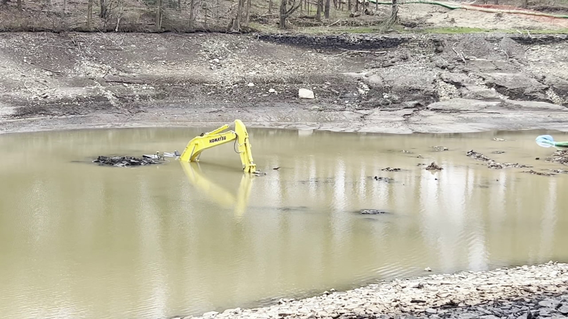 An excavator that was being used in a dam improvement project fell into Curtis Reservoir near Elmhurst Friday afternoon, according to Pennsylvania American Water.