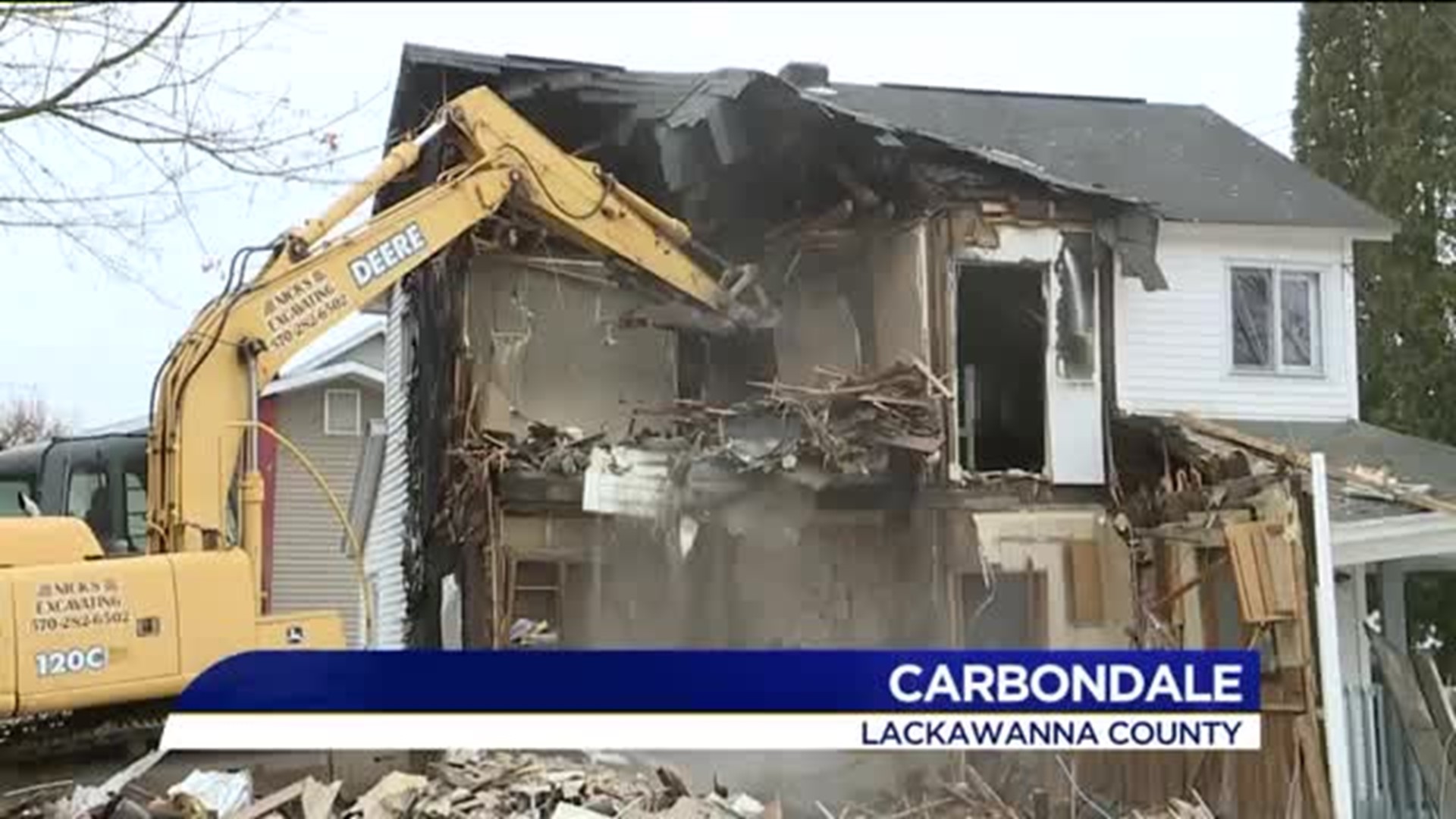 Crews Work to Tear Down Home Destroyed by Fire in Carbondale