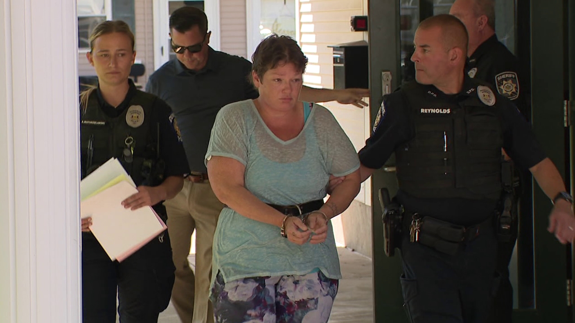 Christine Hessmiller is charged with involuntary manslaughter after assaulting a coworker inside an elementary school, who died shortly after, according to police.