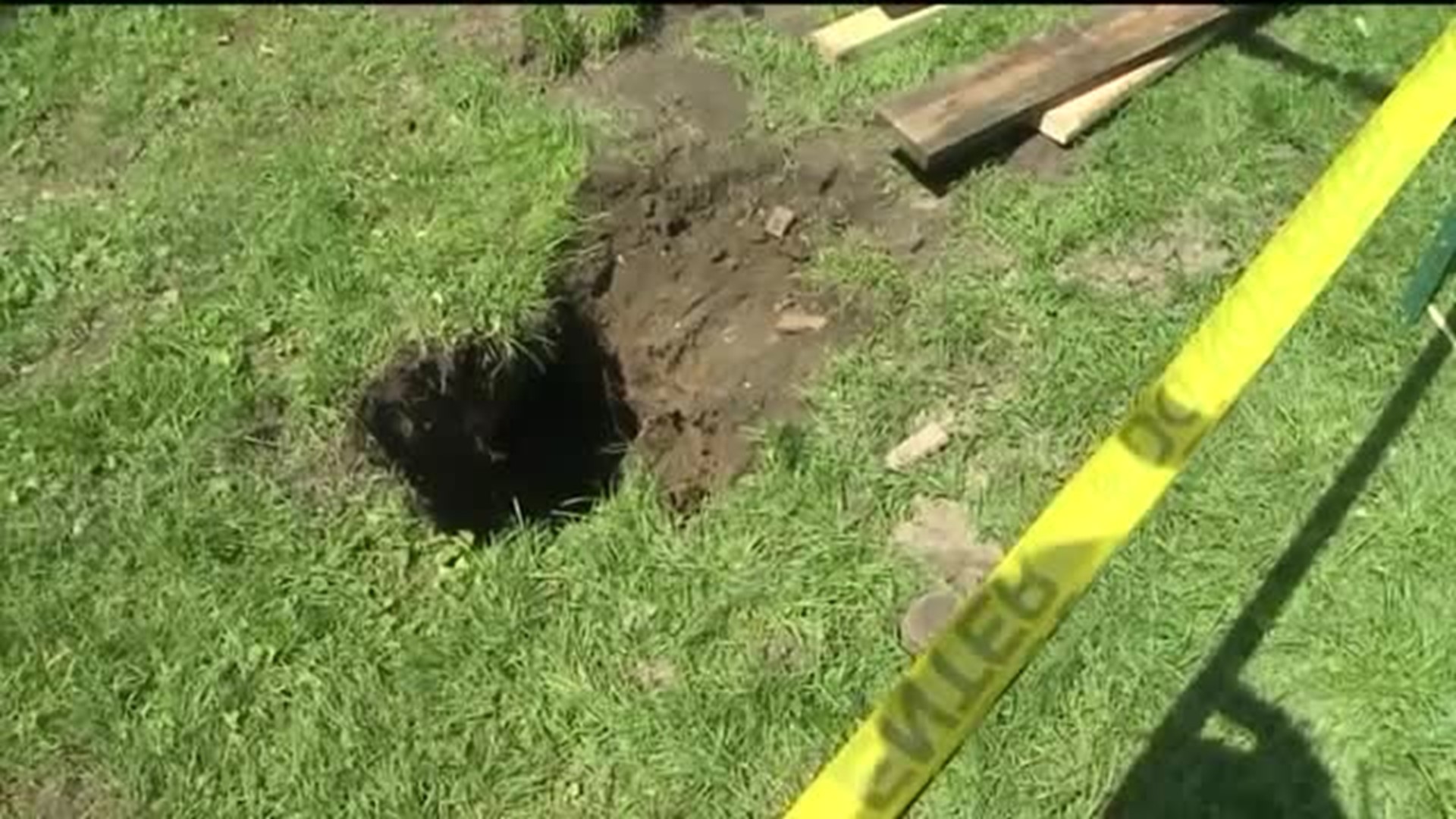 Backyard Sinkhole Tries to Swallow Up Family's Motorcycle