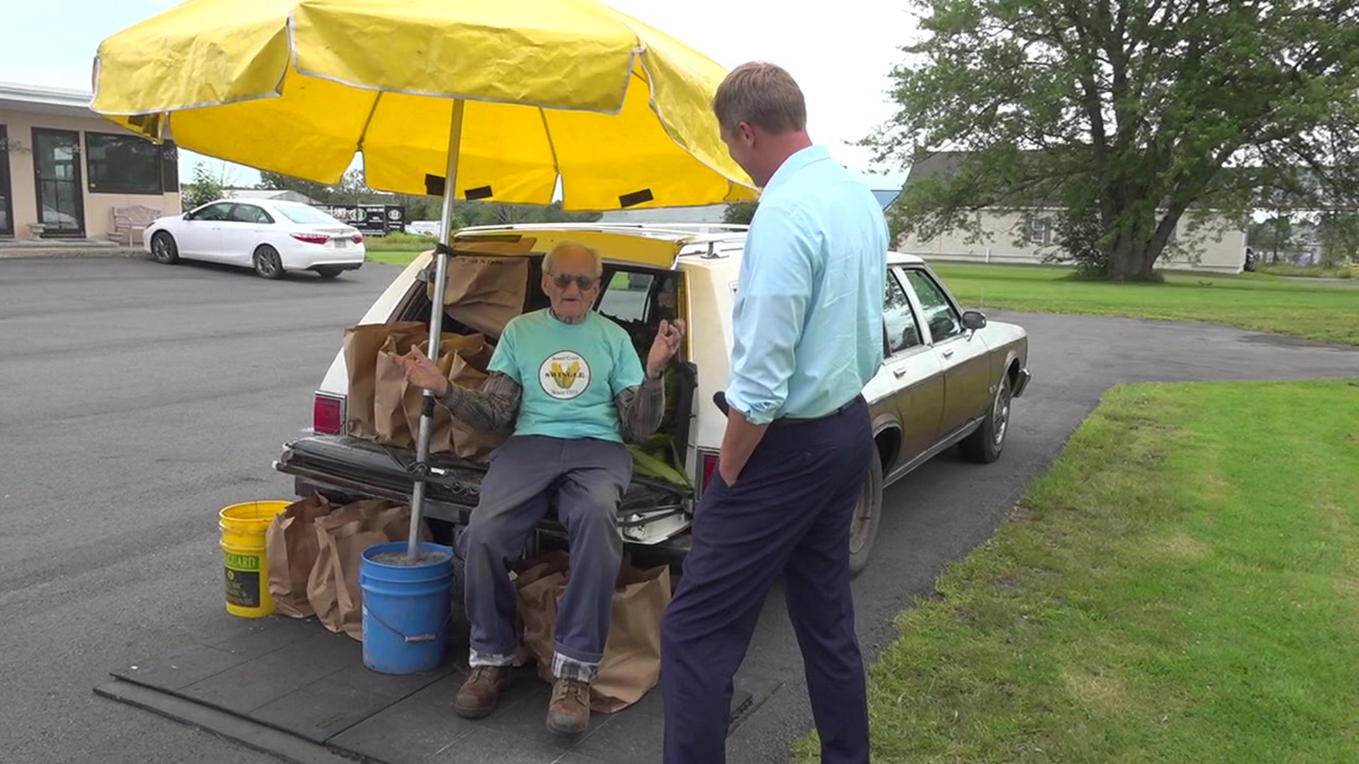 All you have to do is see the station wagon, umbrella, and older gentleman to know this is a unique corn stand, but it's much more of a story than that.