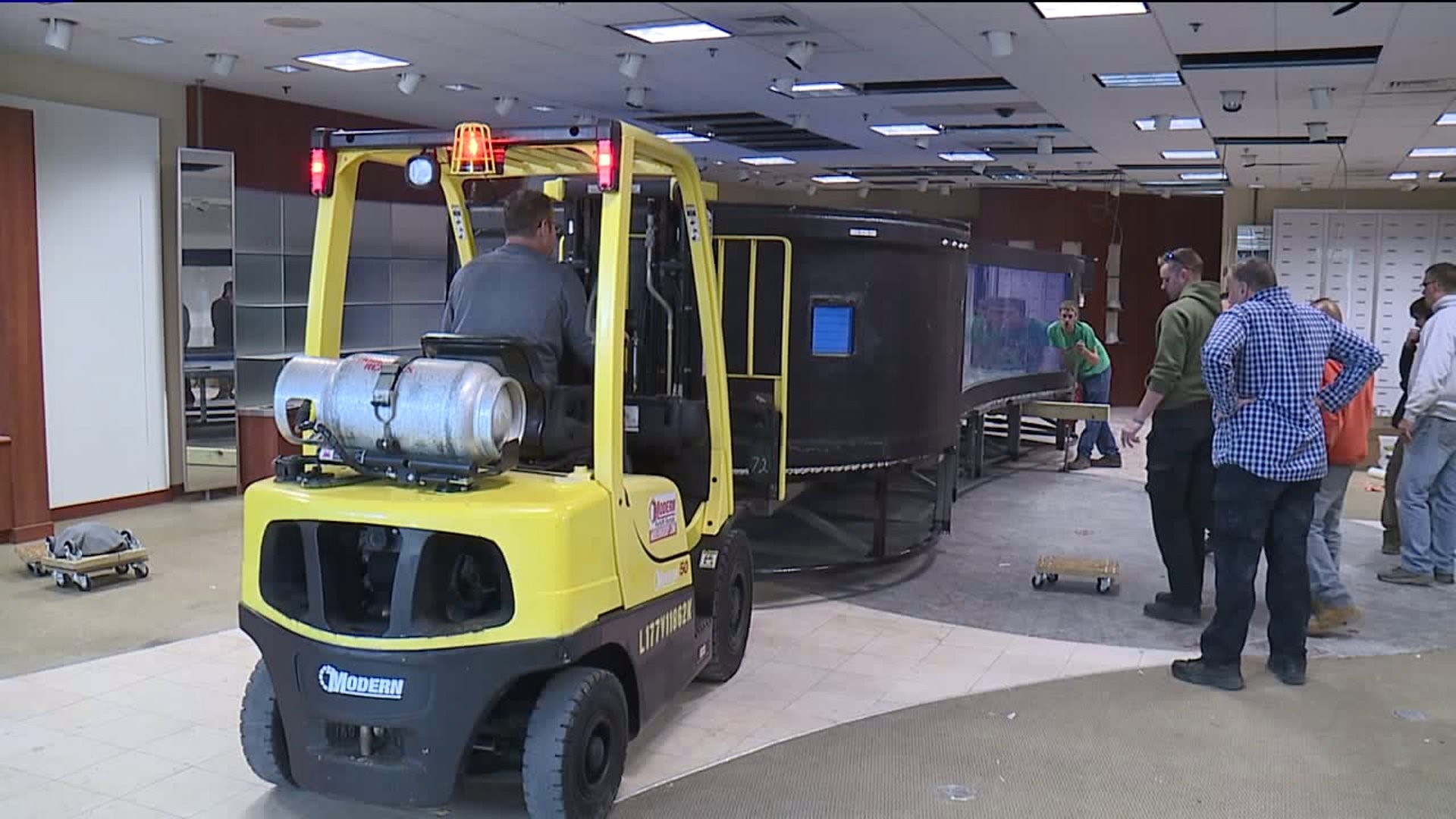 Workers Install Tanks for Electric City Aquarium