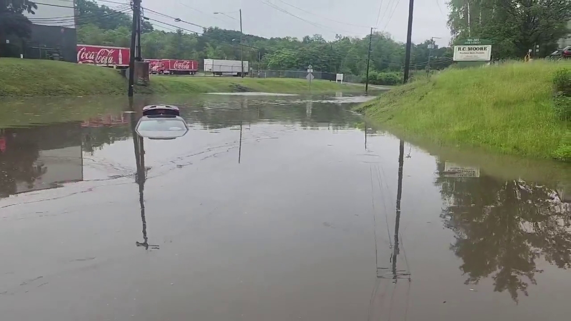 Flooding on Saturday morning has closed Oak Street in Pittston at the Brown Street intersection, leaving a car submerged.