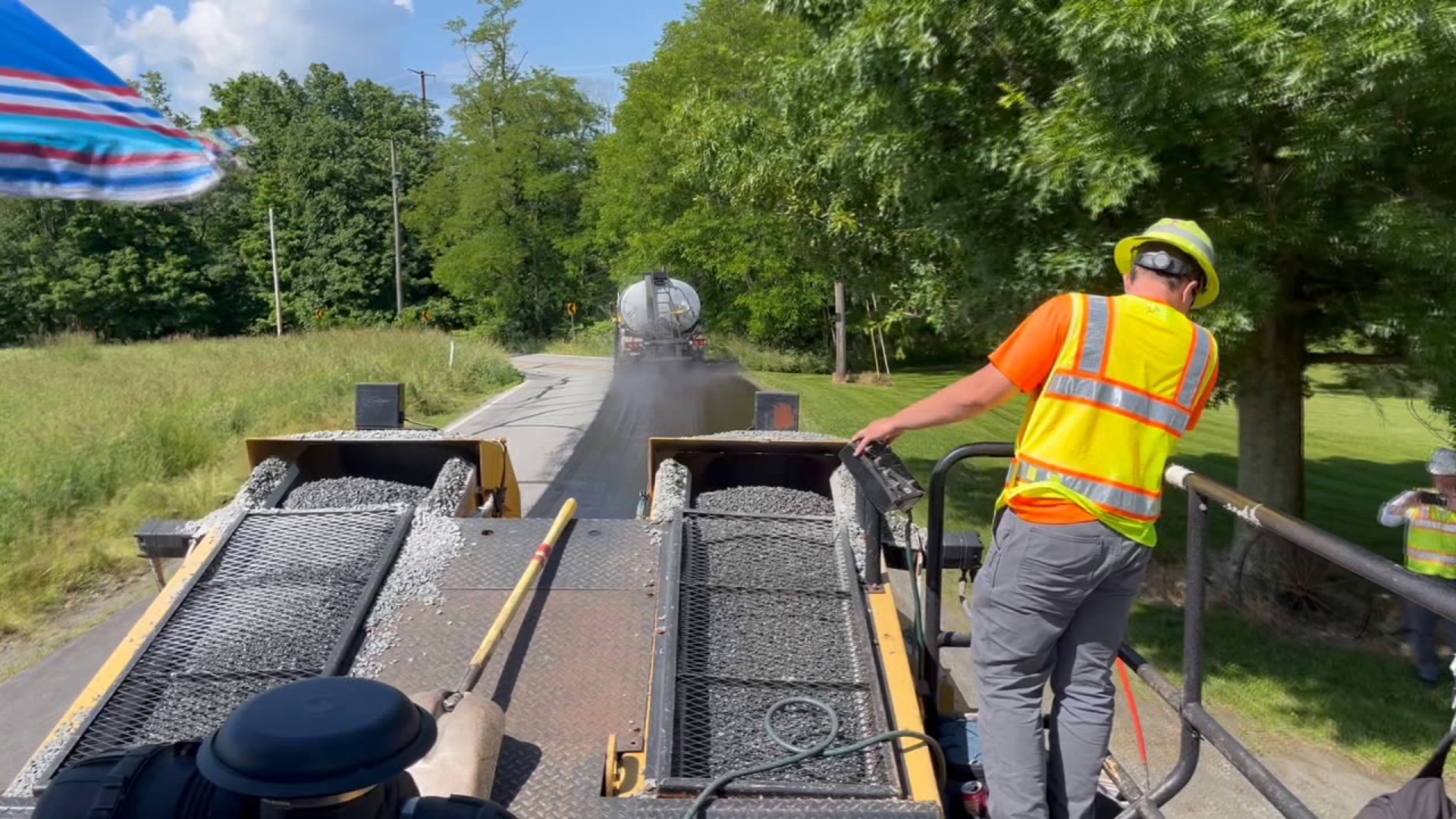 WNEP's Ally Gallo gets to hop on the stone chipper as crews from PennDOT seal coat a road in Lackawanna County