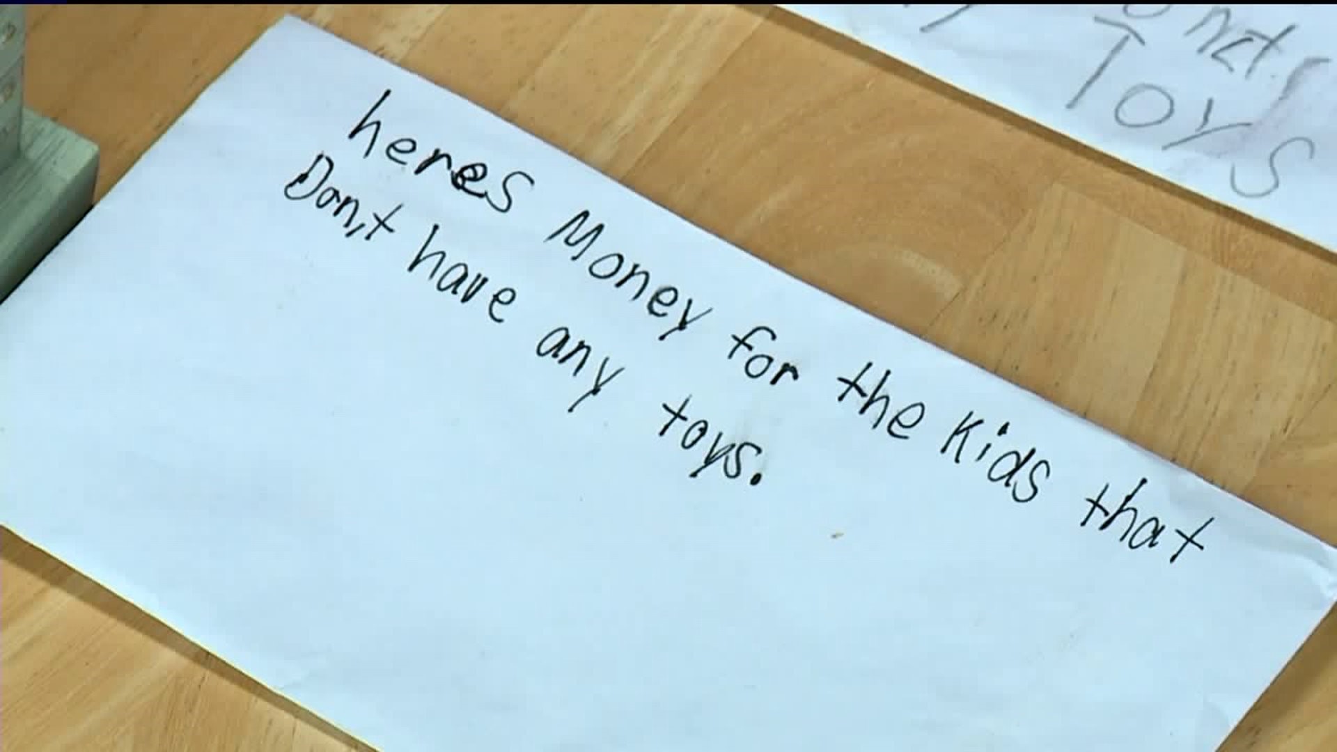 Children Give Money to Santa to Buy Toys for Those in Need