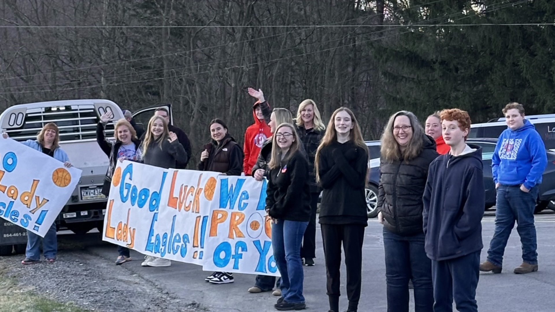 As the team left the school, fans lined the streets with signs to wish the girls luck.