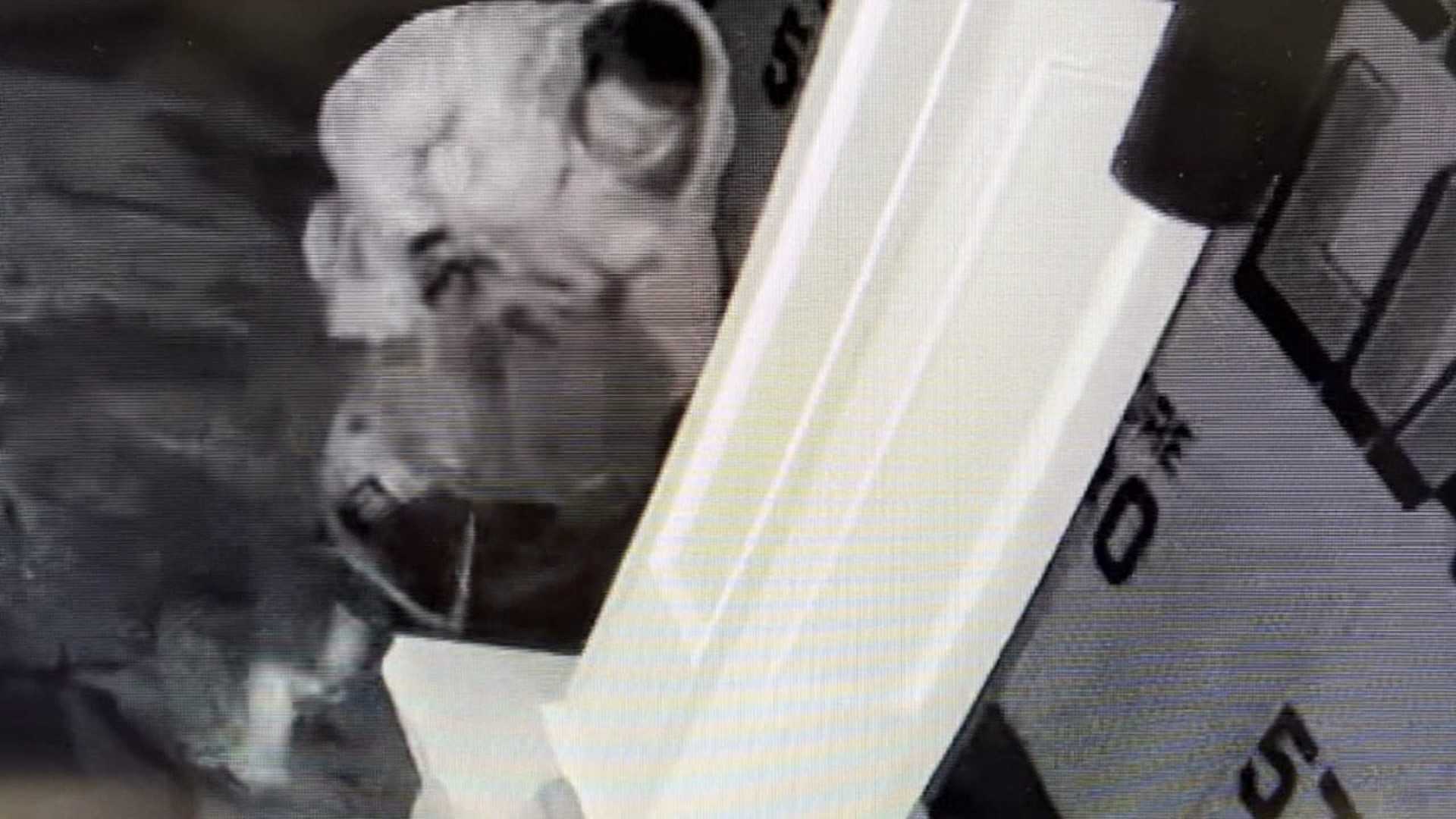Surveillance video shows the suspect stealing a catalytic converter from a delivery truck.