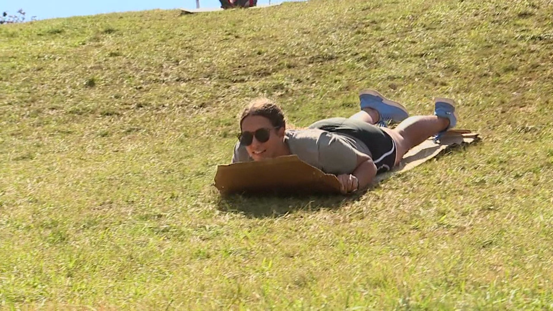 Sliding down the hill near Lamade Stadium has been a fun tradition for generations of baseball fans