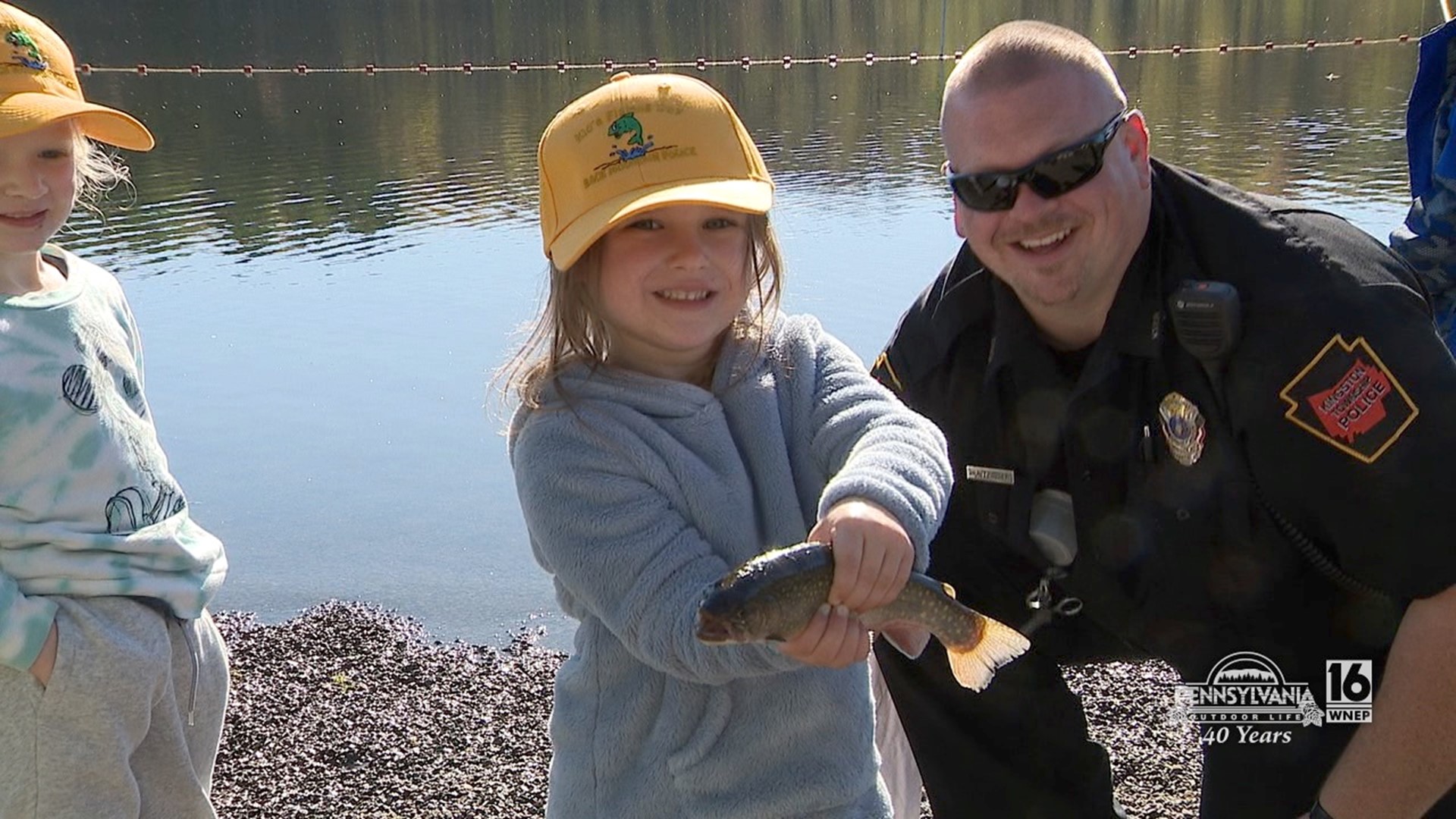 Kids getting to know their local law enforcement through fishing.