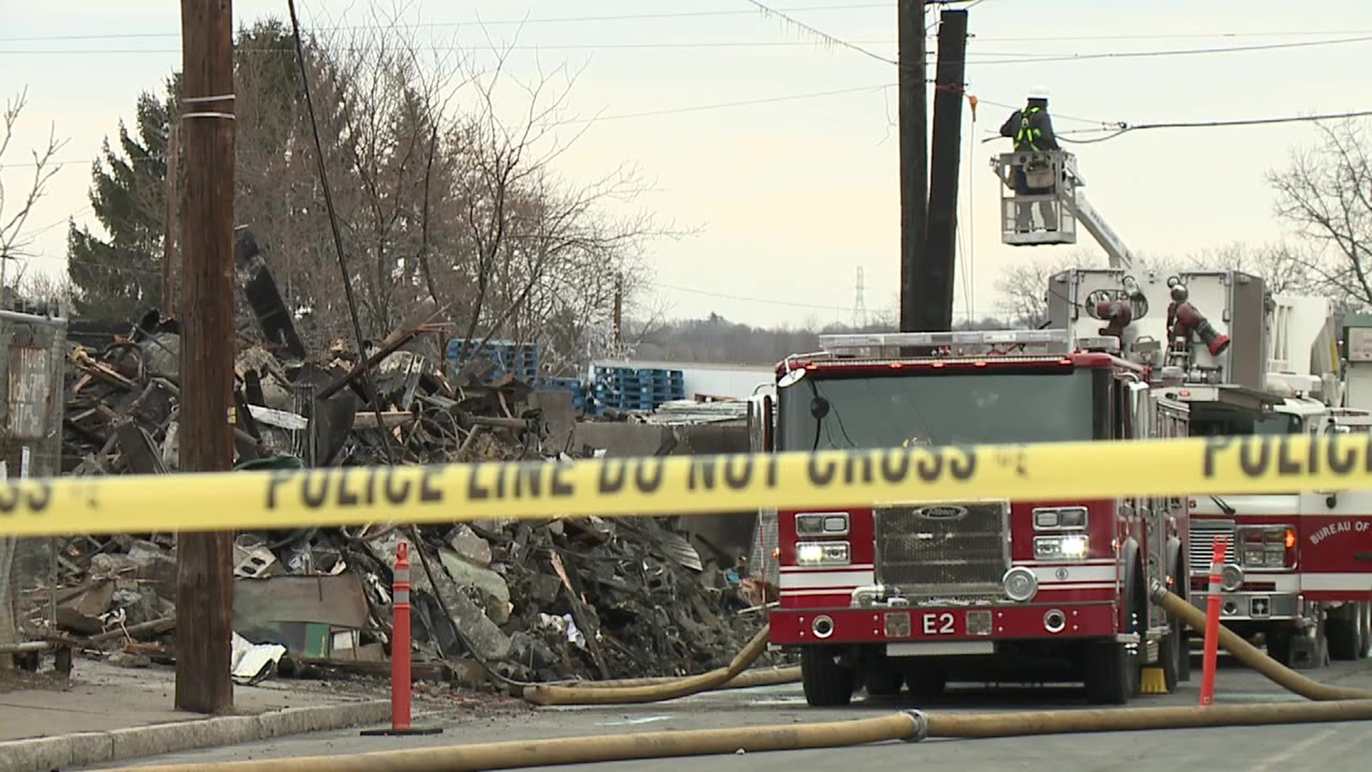 Crews continued to fight remnants of Monday's massive fire at a scrap and recycling center in Wilkes-Barre.