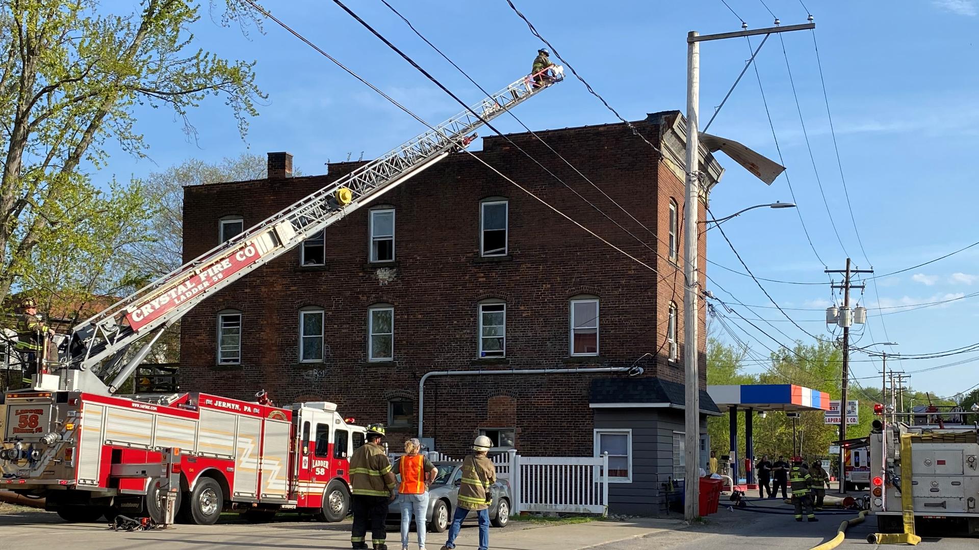 According to fire officials, a metal piece from a roof in an apartment building was blown off by the wind, causing it to touch with power lines and spark a fire.