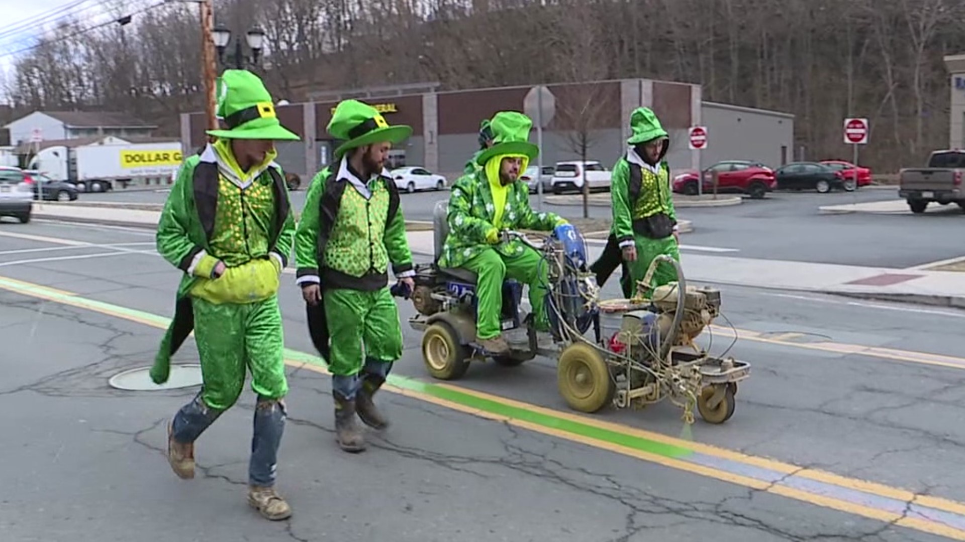 Crews in festive outfits painted a green line along the route for the annual parade, set for Saturday, March 4.