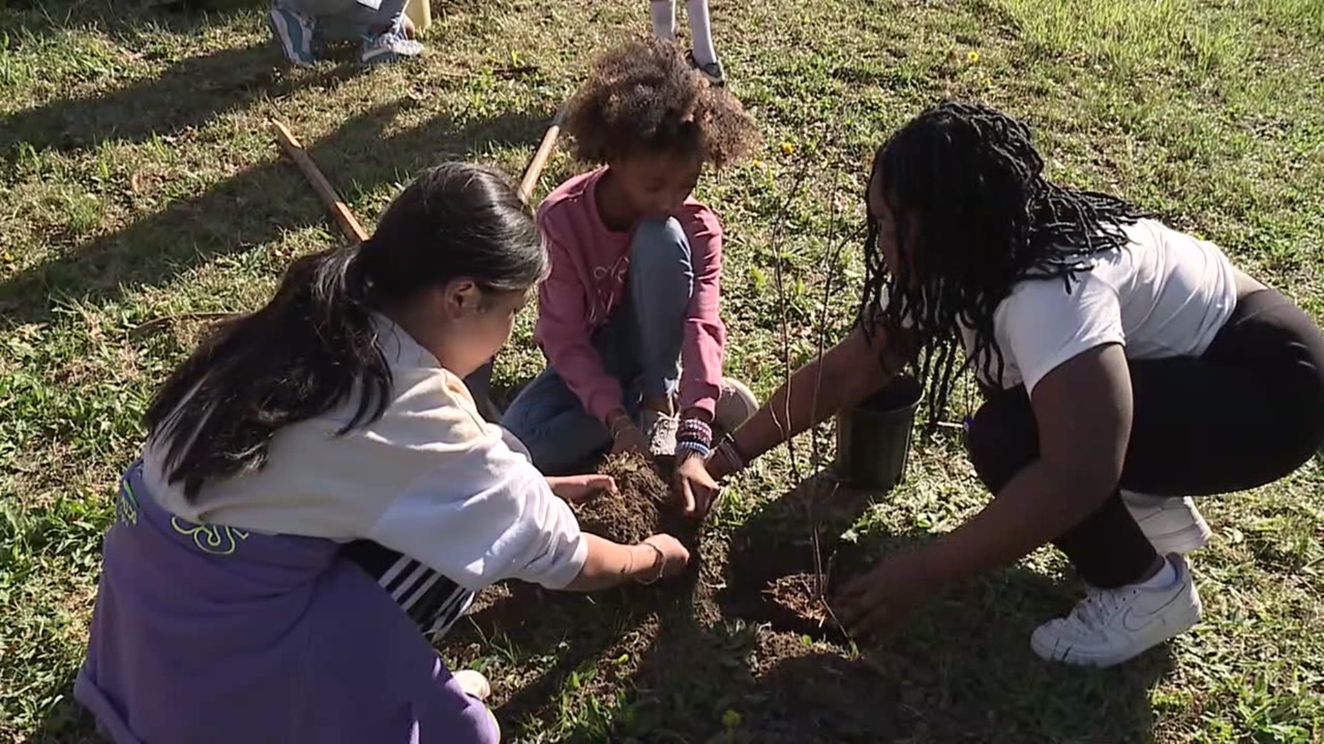 Children from DHH Lengel Middle School planted trees and shrubs native to the Commonwealth near Martz Hall.