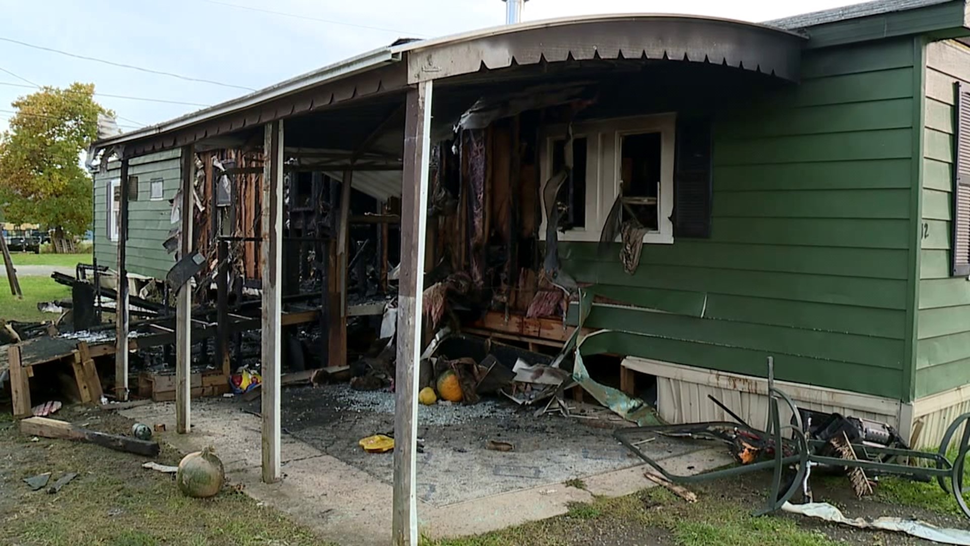 Community help family sort through rubble after home was destroyed in fire.