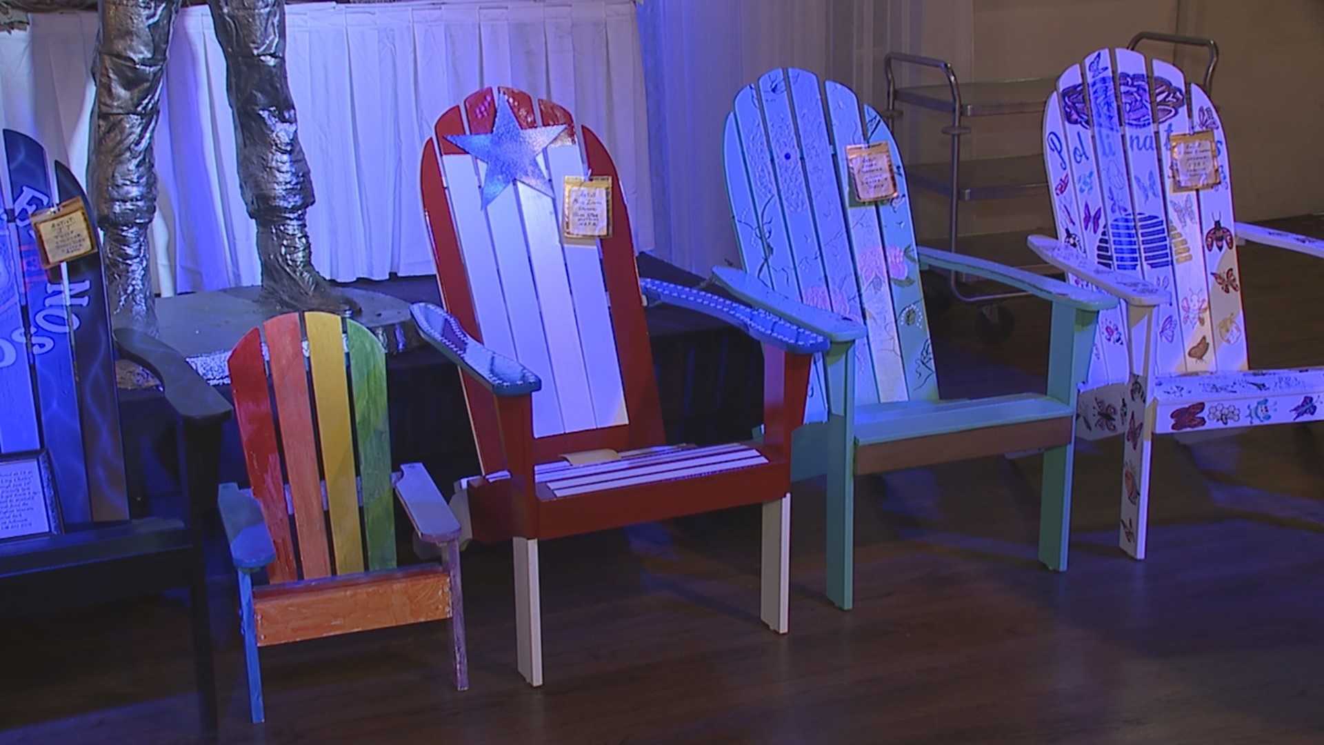 Artists used their creative expression to design Adirondack chairs that are up for auction.