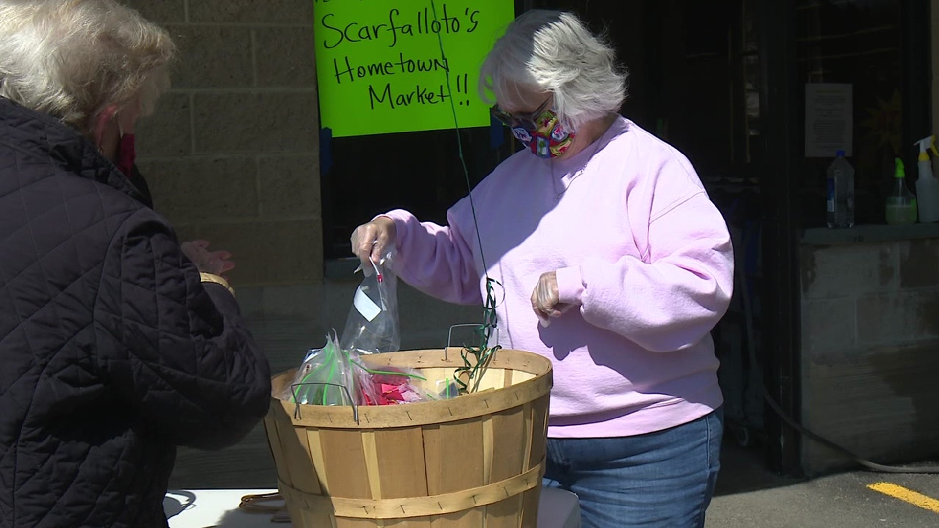 Volunteers have been sewing masks and giving them away for free outside of Scarfalloto's Hometown Market.