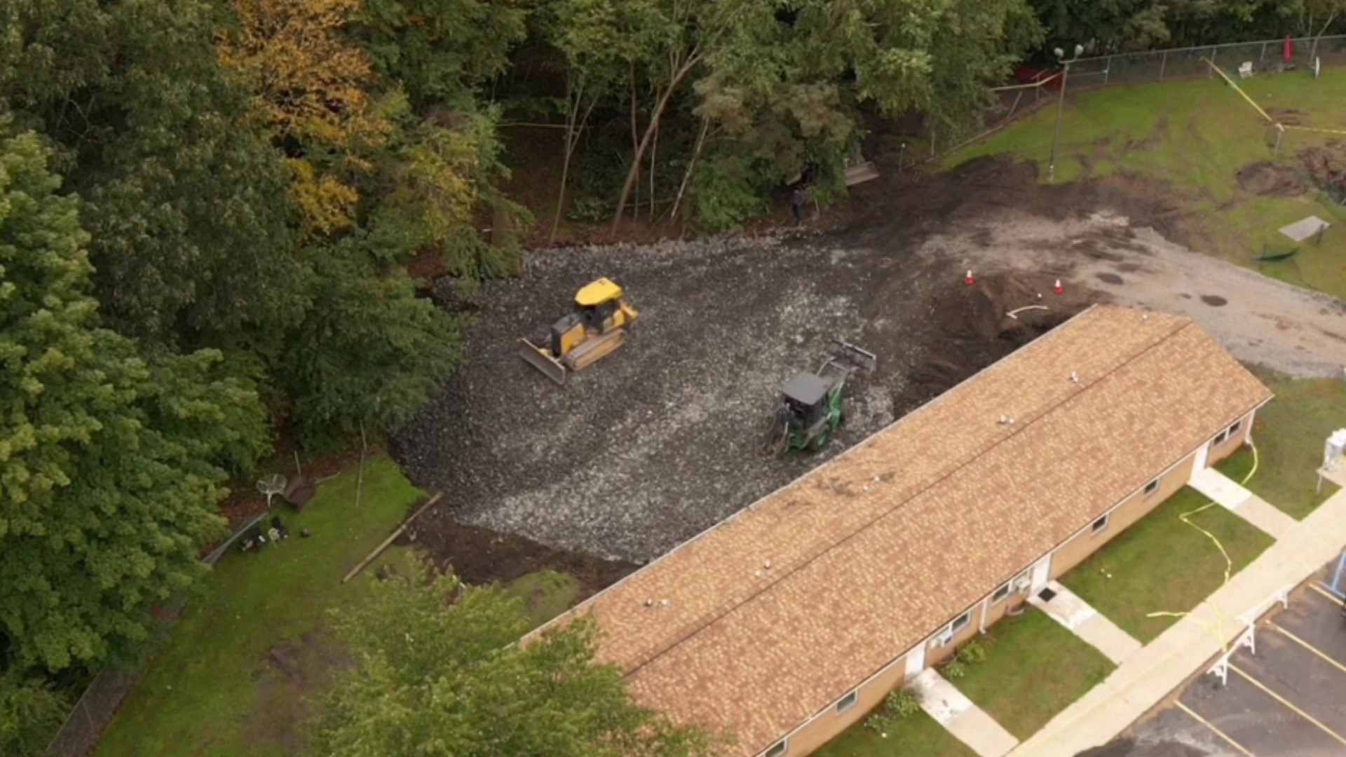 Four days after a giant sinkhole opened at a housing complex in Luzerne County, crews continue to work to fill the void.