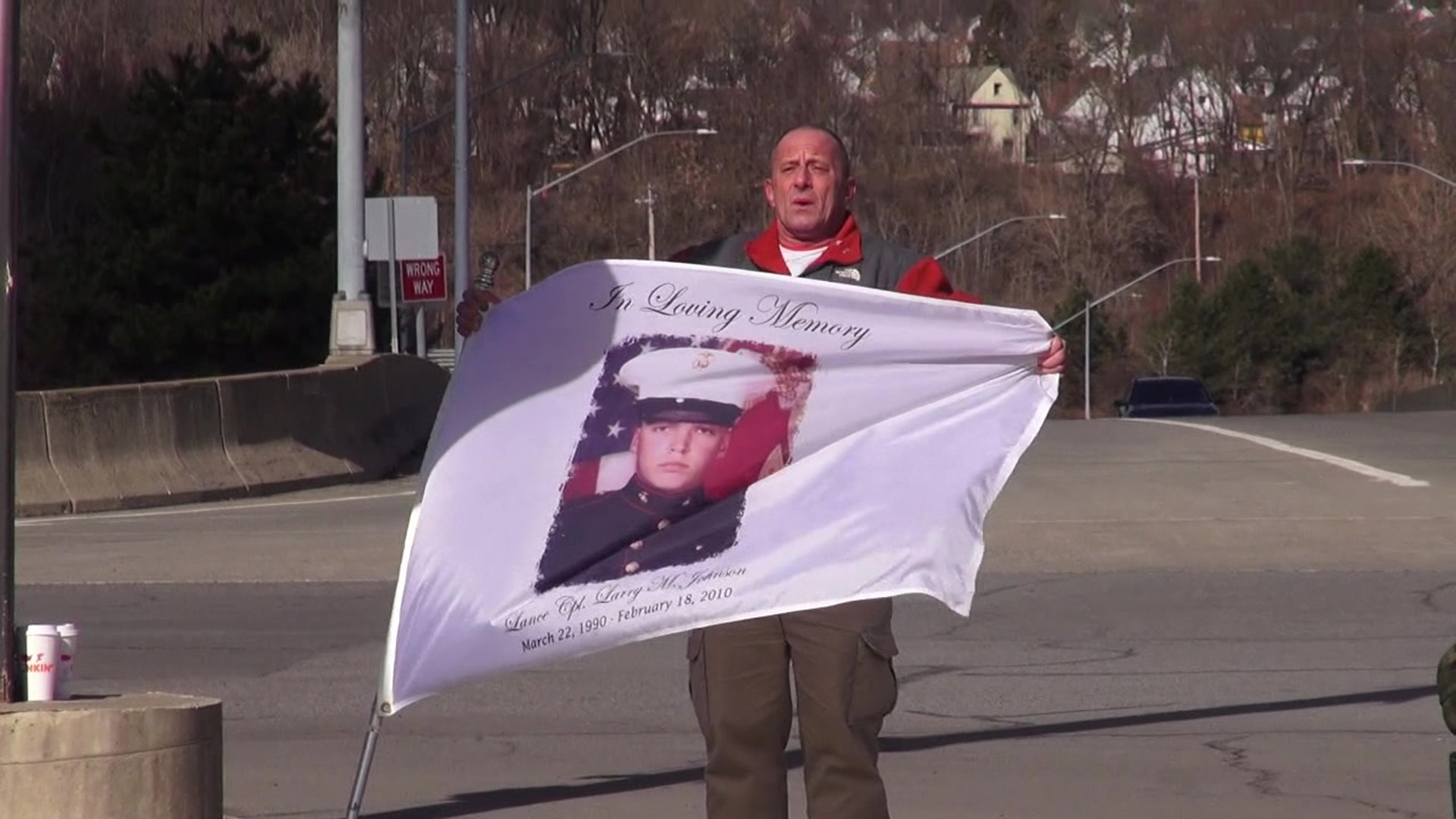 A Marine from Lackawanna County is being remembered on the anniversary of his death, with his stepfather braving the elements to hold his flag for all to see.