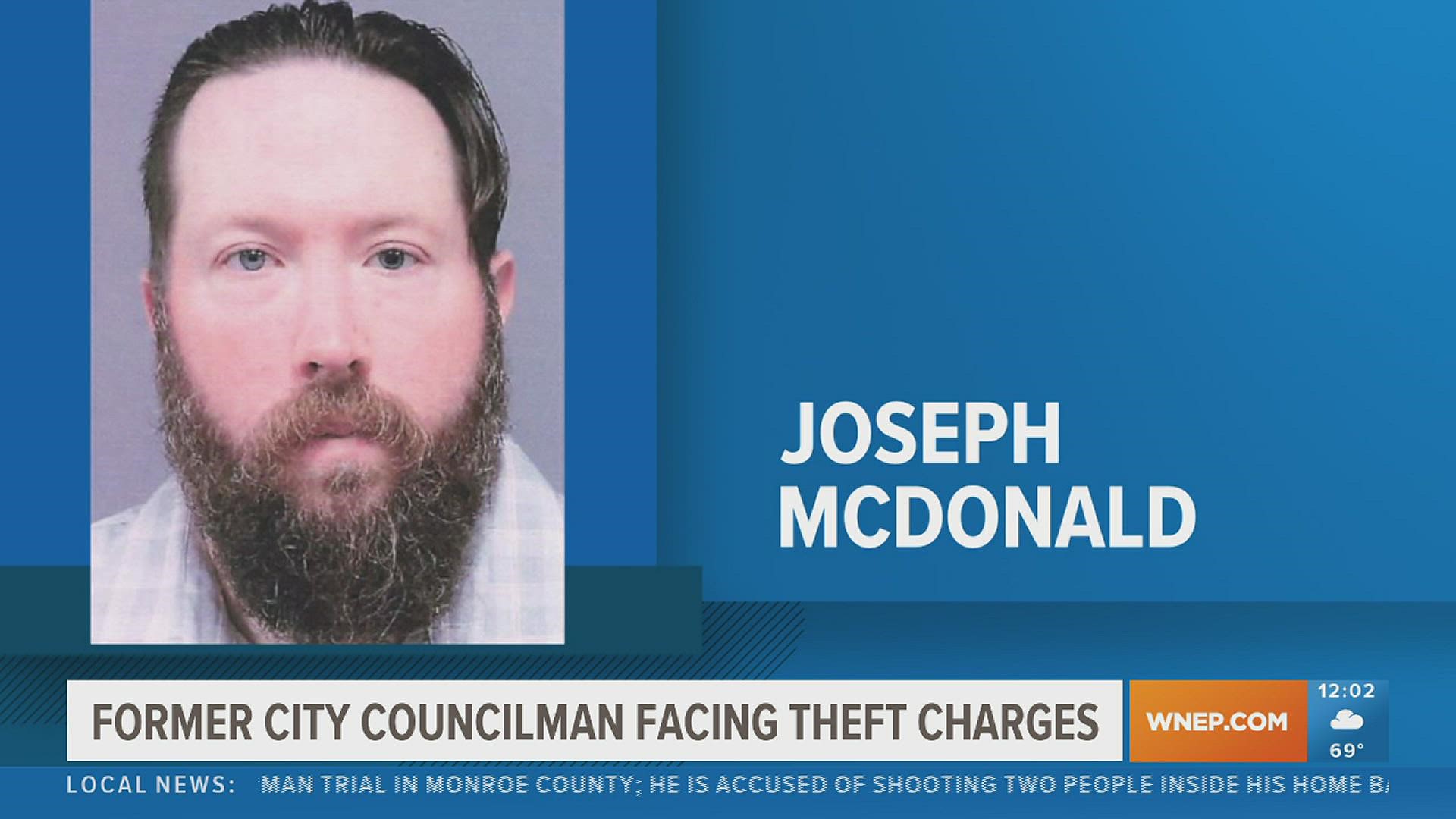 A former city councilman in Lackawanna County turned himself in Monday morning to face theft and forgery charges.