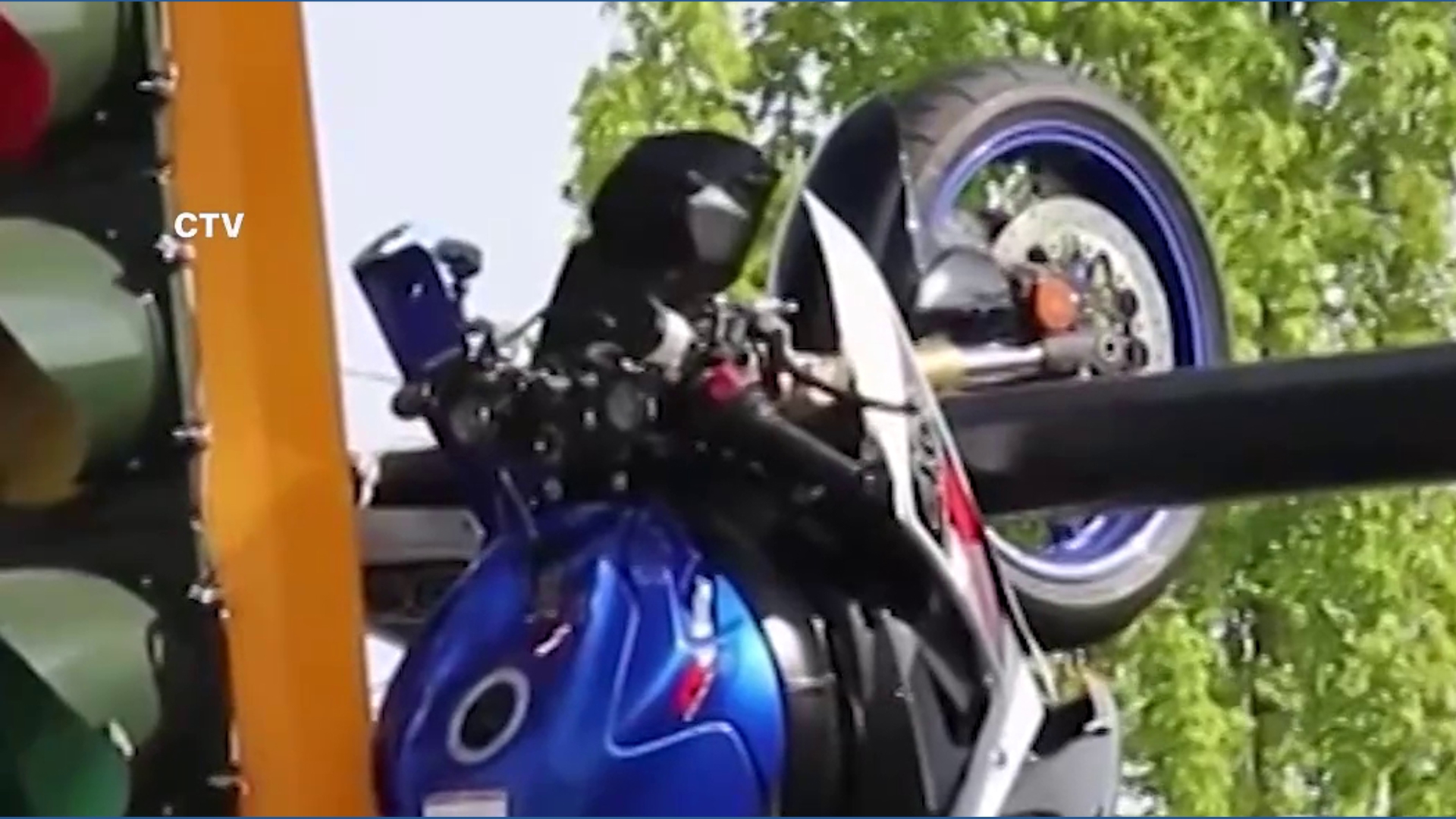 Motorcycle left dangling from traffic light pole after crash in Canada ...