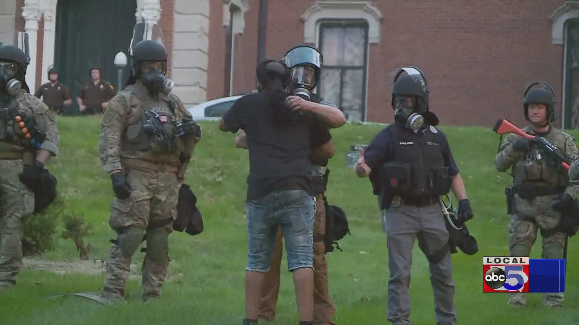 Protesters, law enforcement embrace at governor's mansion