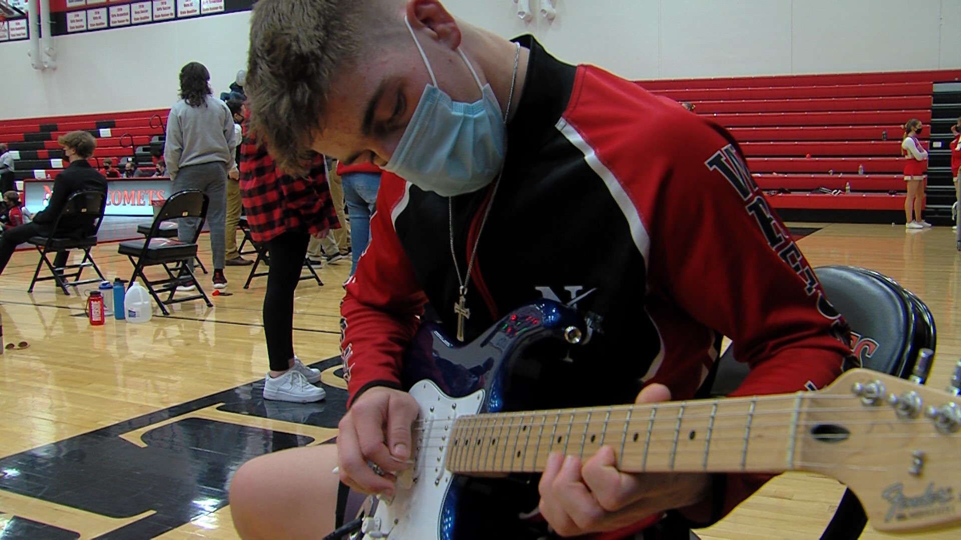 Chance Bockenstedt sets the tone for home wrestling duals with his version of the National Anthem on his guitar.