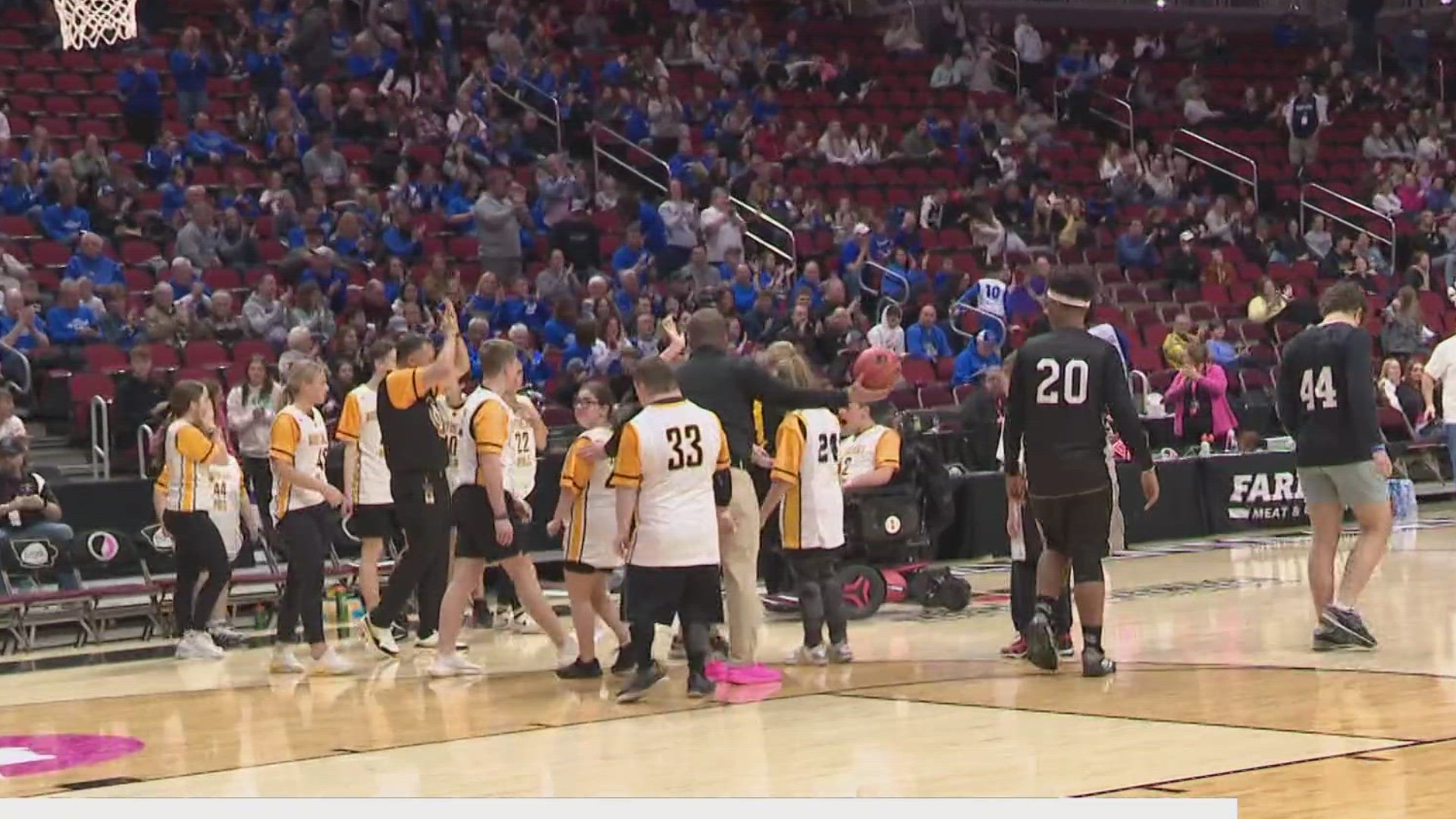 The Southeast Polk and Ankeny Centennial unified basketball teams took the floor during halftime of the Class 2A girls state tournament semifinal game.