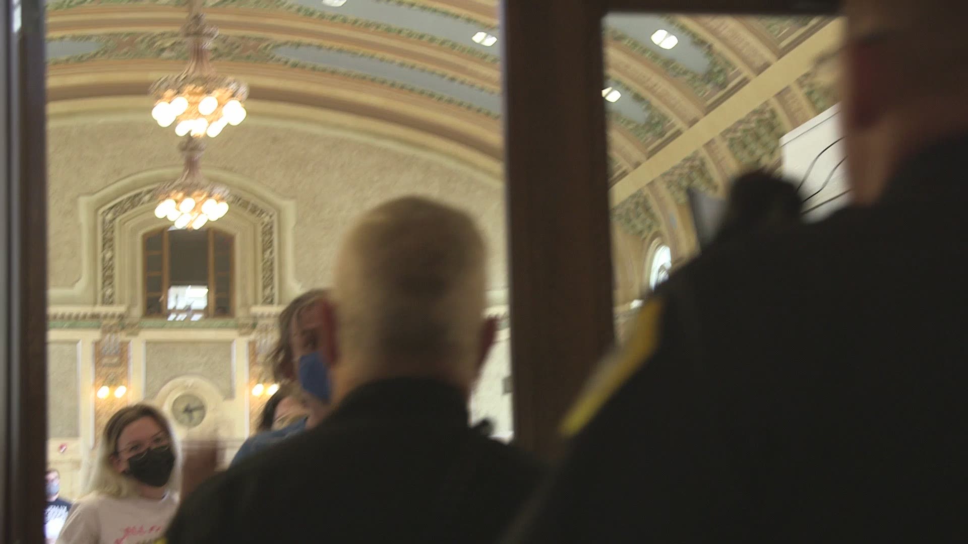 After standing on chairs and booing Des Moines City Council members, police escorted protesters out of the chambers and asked them to leave the building entirely.