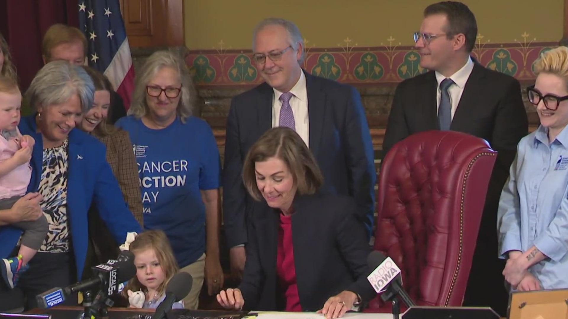 Gov. Kim Reynolds on Wednesday signed over 40 bills into law, with two of them involving insurance coverage for cancer care.