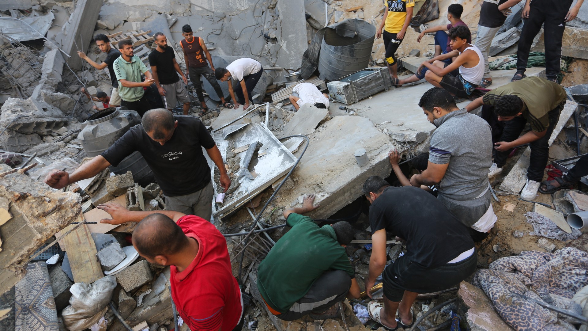 Israeli airstrikes level apartments in Gaza refugee camp, as ground