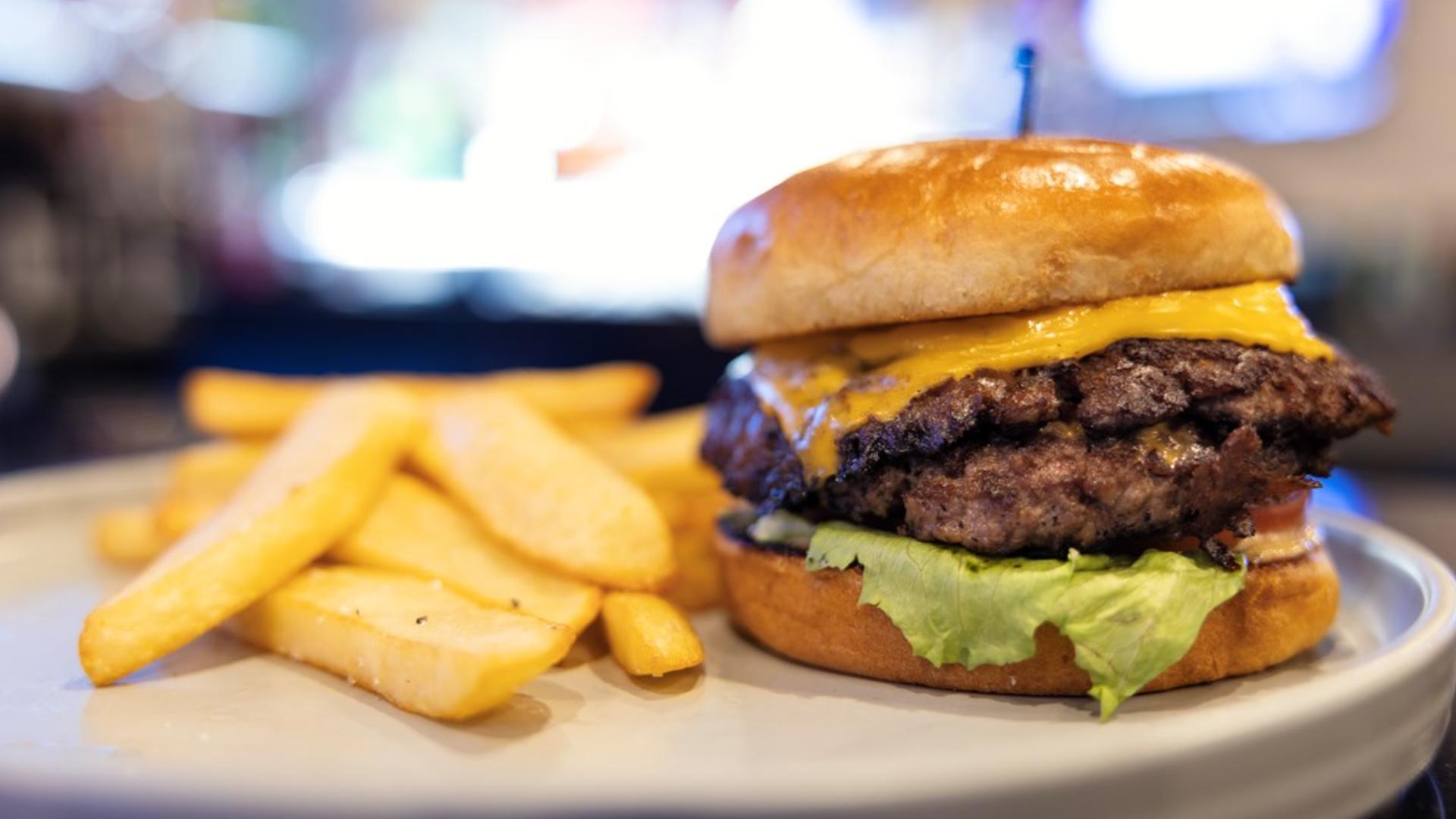 The JJ Smash Burger is a tasty combination of beef, tavern sauce, American cheese, lettuce, red onion and pickle.