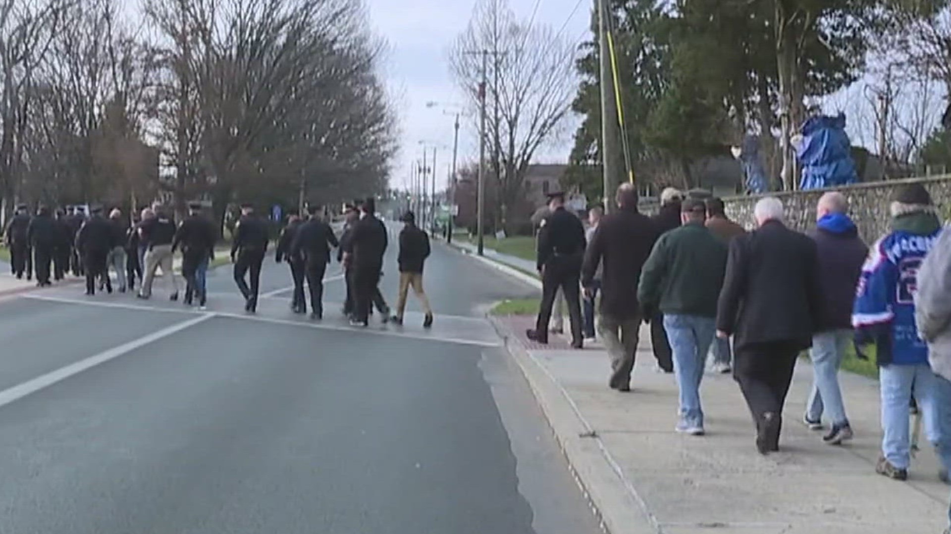 Local law enforcement and community members followed the same route Lt. William Lebo walked to work for 40 years.