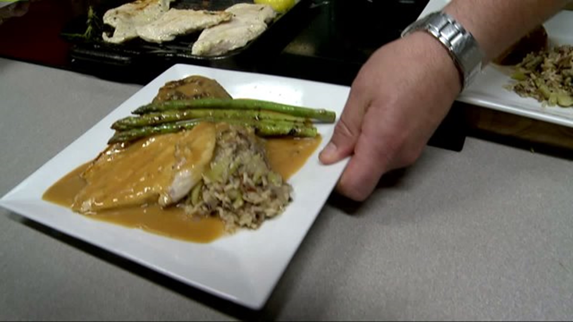 Fire grilled caramel chicken & asparagus served w brown wild rice & baked apples presentation