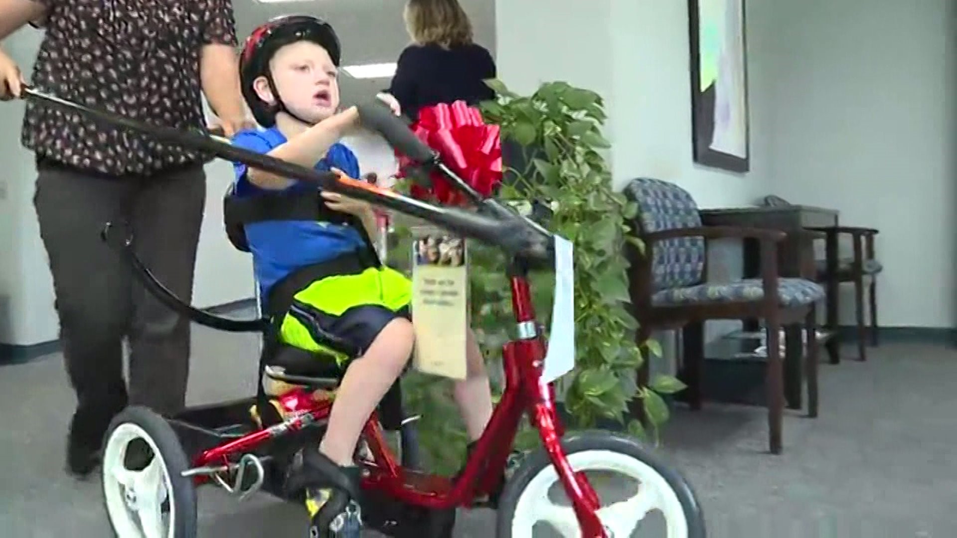 Children with disabilities receive adaptive bikes