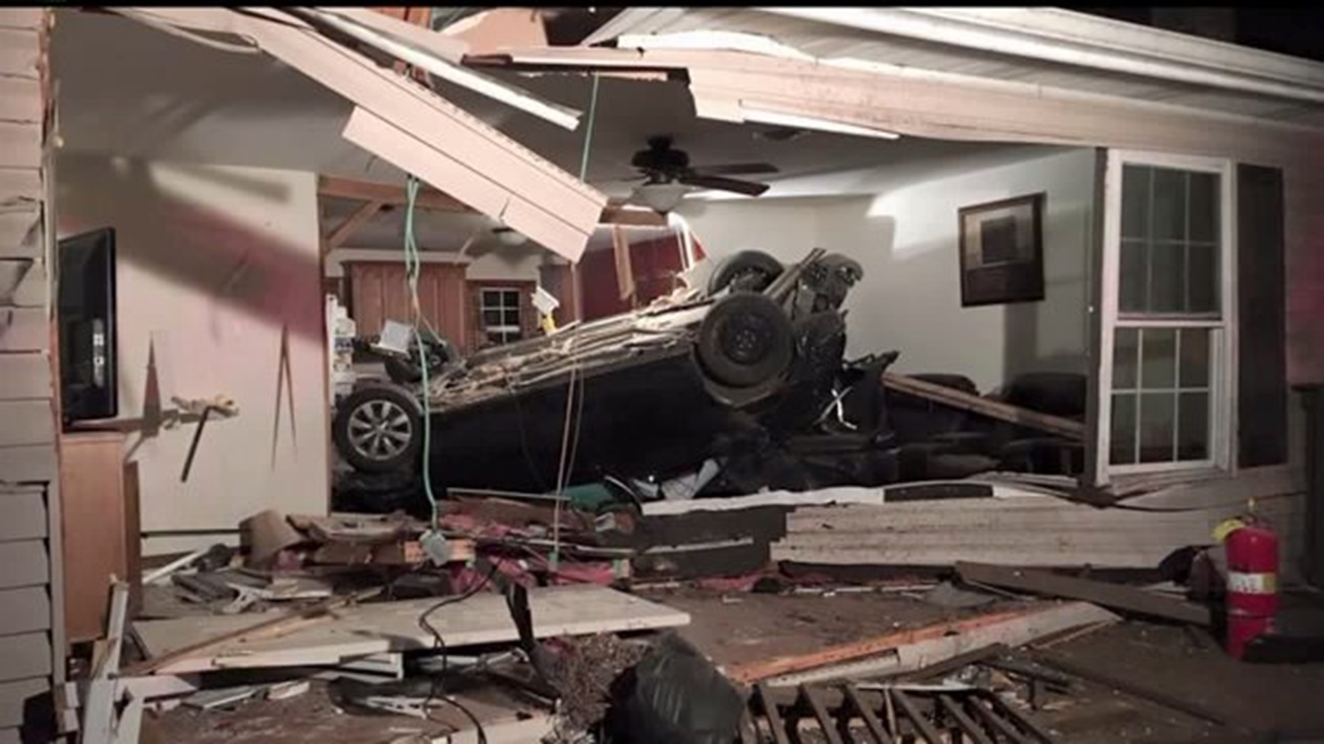 Car crashes into house, injures woman
