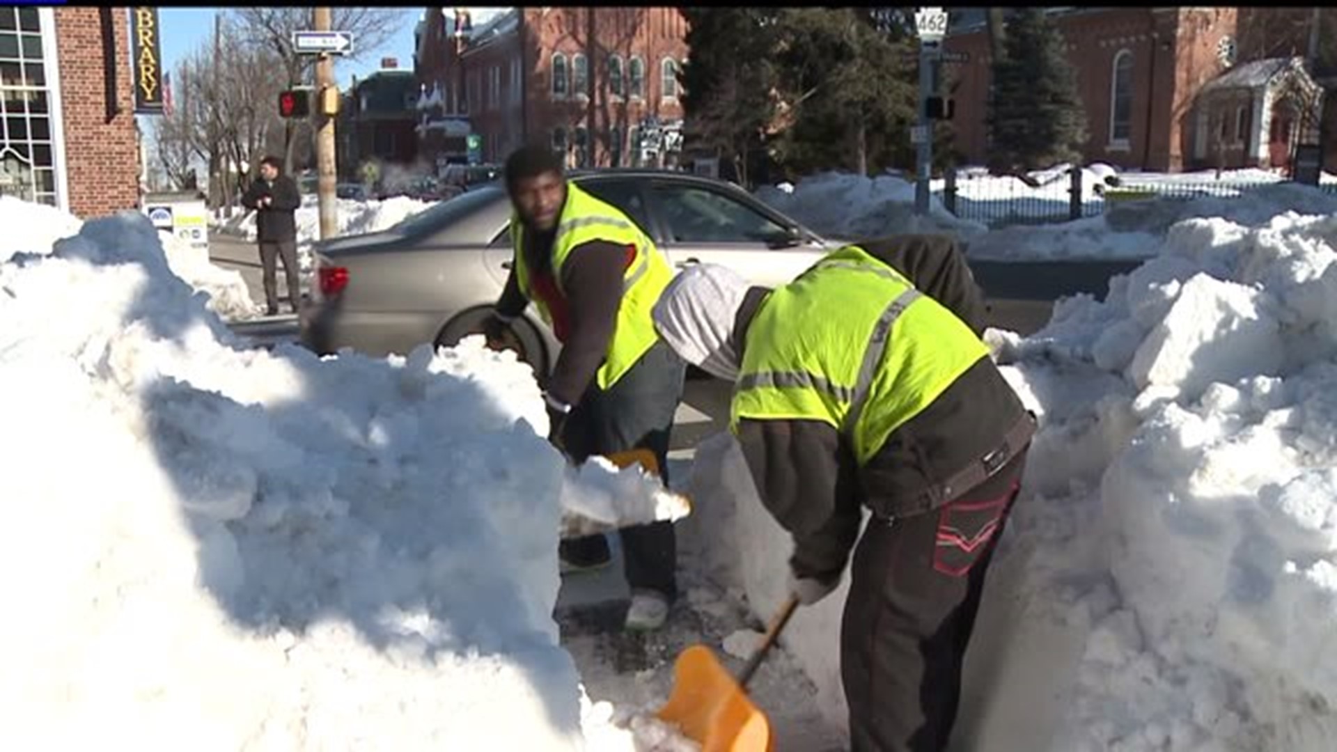 Prison inmates help dig out crosswalks and sidewalks buried under snow in York City